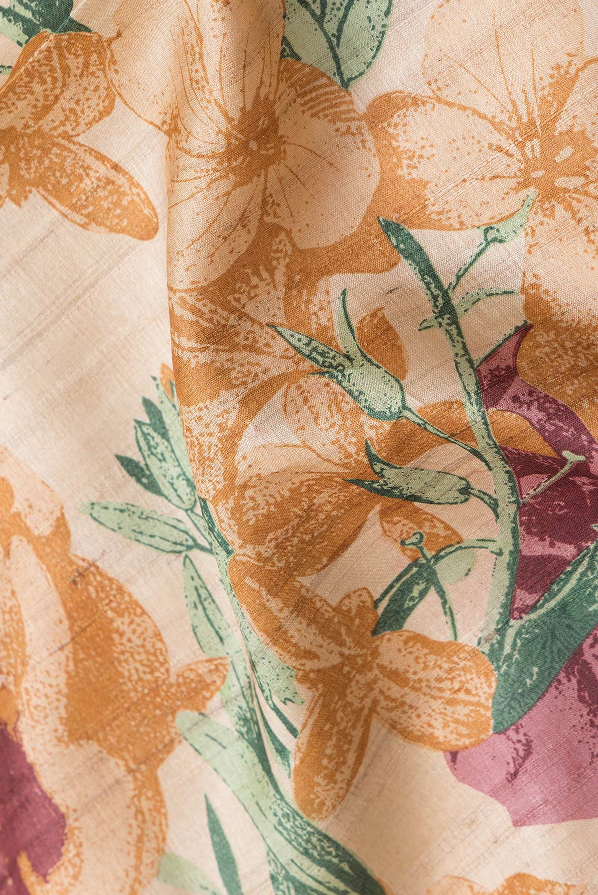Close up of Beige Dual Tone Tussar Silk Saree with Printed design on the body and Embroidery Border.  displaying folds