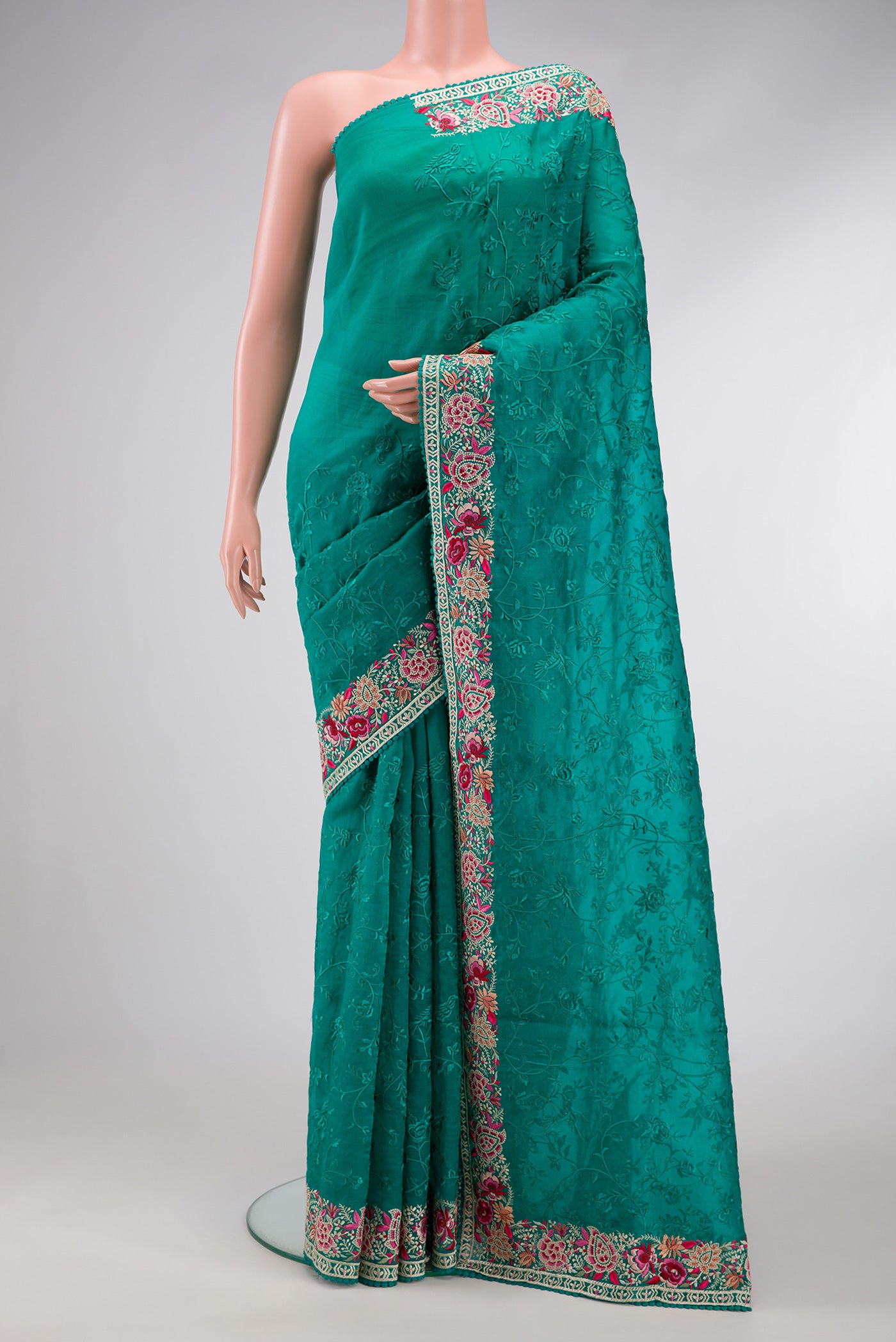Green Dual Tone Organza Silk Saree with Embroidery on the body and Embroidery Border.  displayed on a mannequin