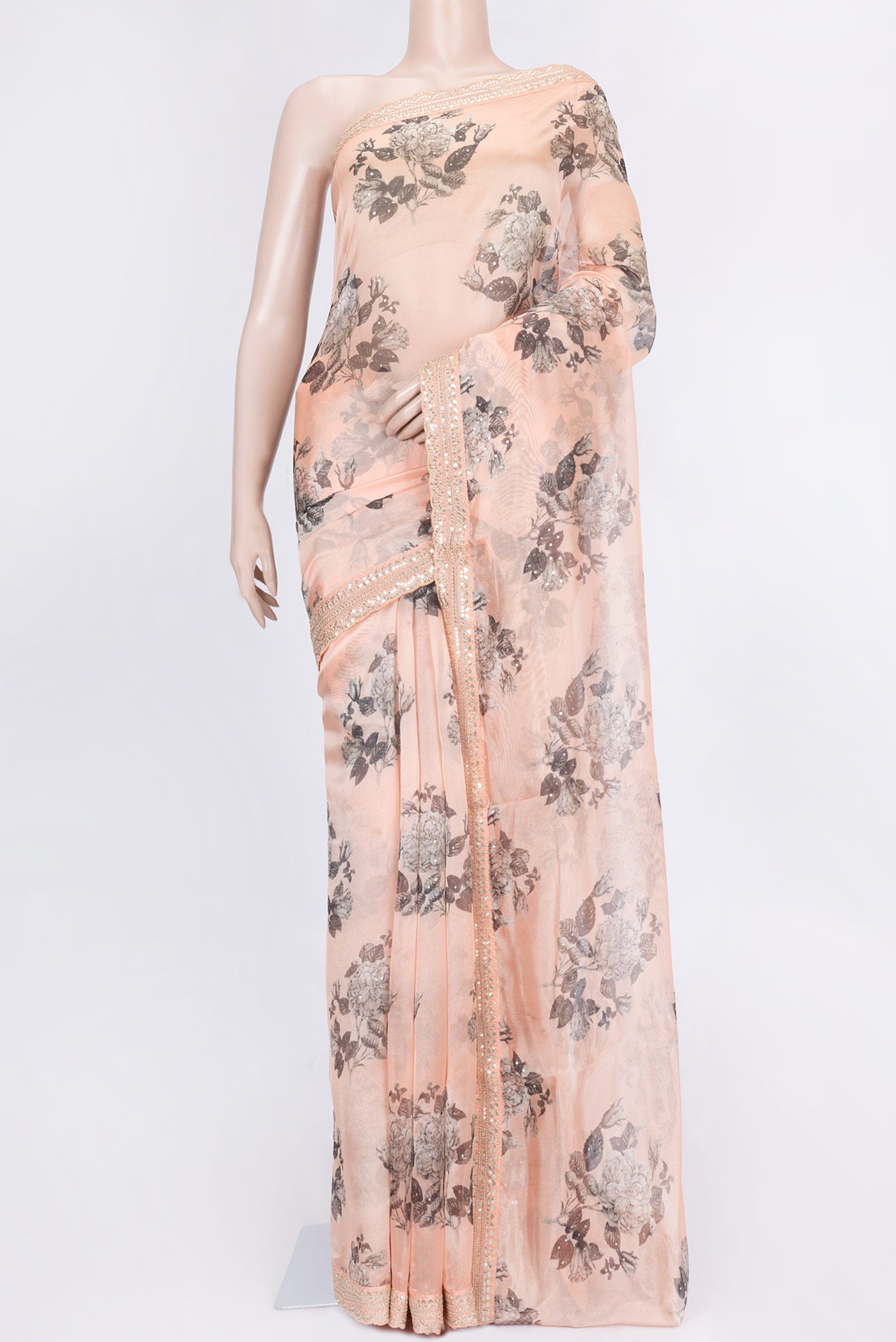 Peach Dual Tone Organza Silk Saree with Zari Butta on the body and Zari Border.  displayed on a mannequin