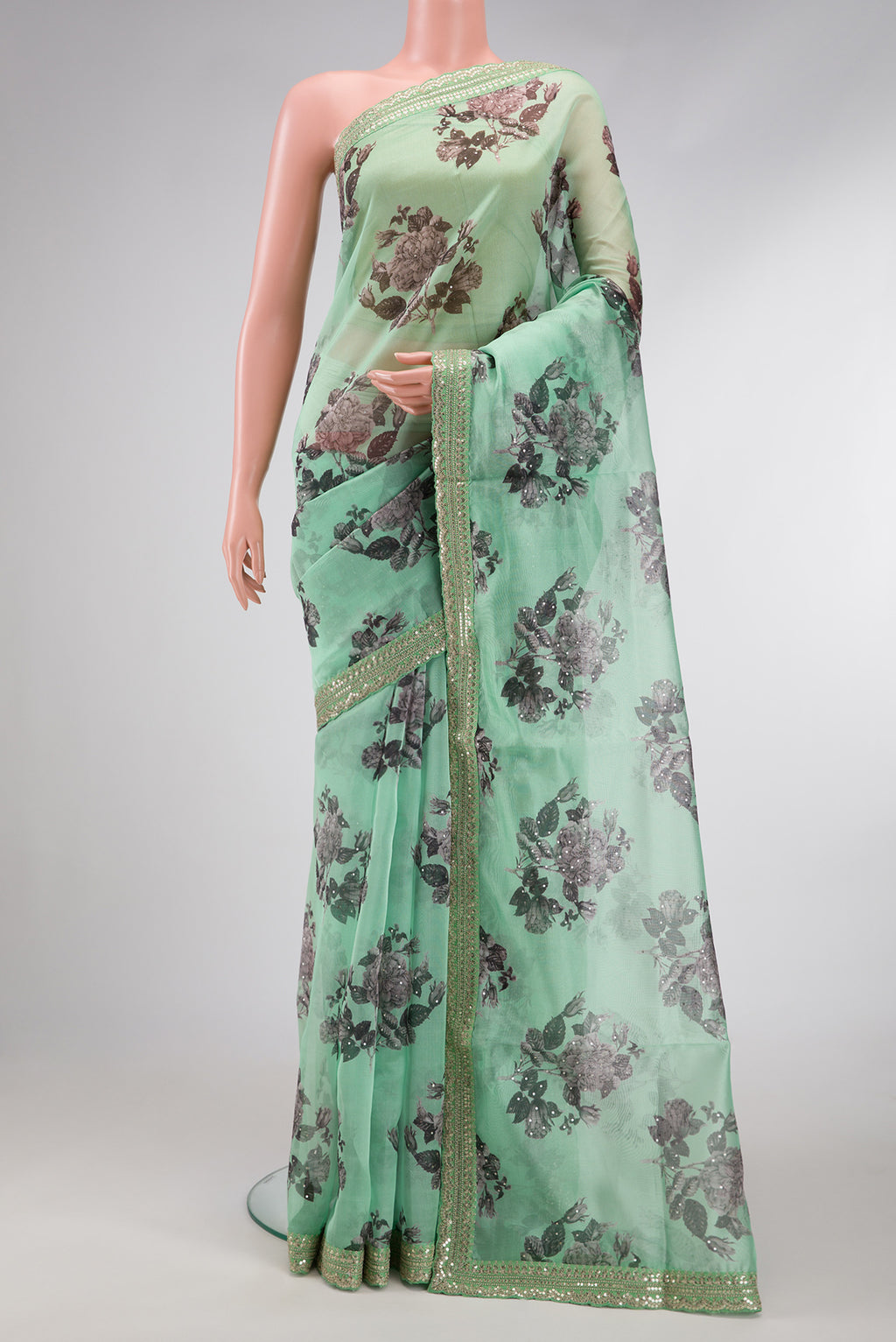 Pista Green Dual Tone Organza Silk Saree with Embroidery on the body and Embroidery Border.  displayed on a mannequin