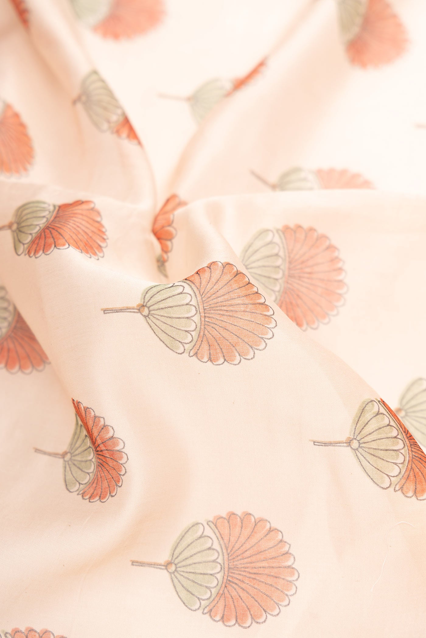 Close up of Golden Peach Dual Tone Chanderi Silk Saree with Printed design on the body and Embroidery Border.  displaying folds