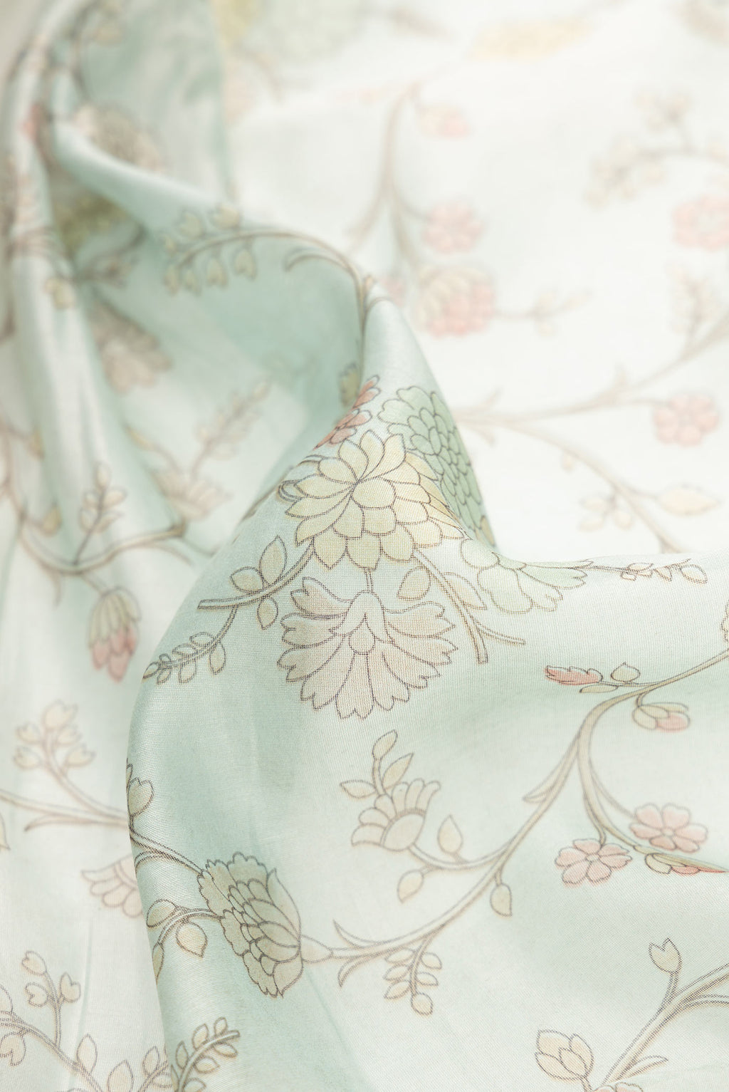 Close up of Light Blue Dual Tone Chanderi Silk Saree with Printed design on the body and Embroidery Border.  displaying folds