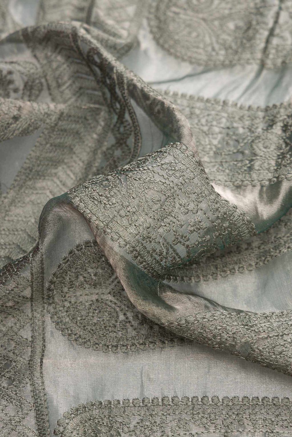 Close up of Grey Dual Tone Mysore Georgette Saree with Embroidery on the body and Plain Border.  displaying folds