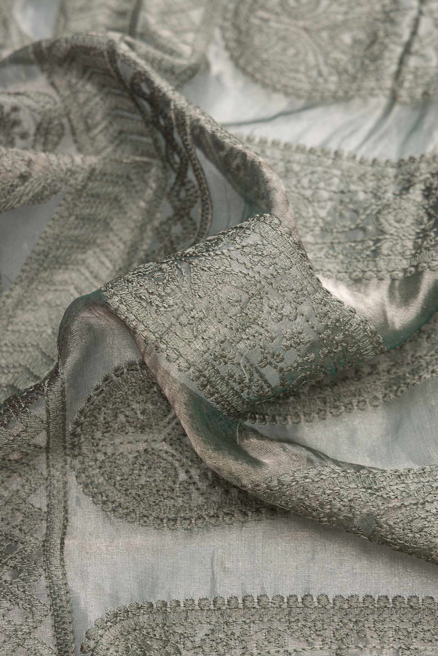 Close up of Grey Dual Tone Mysore Georgette Saree with Embroidery on the body and Plain Border.  displaying folds