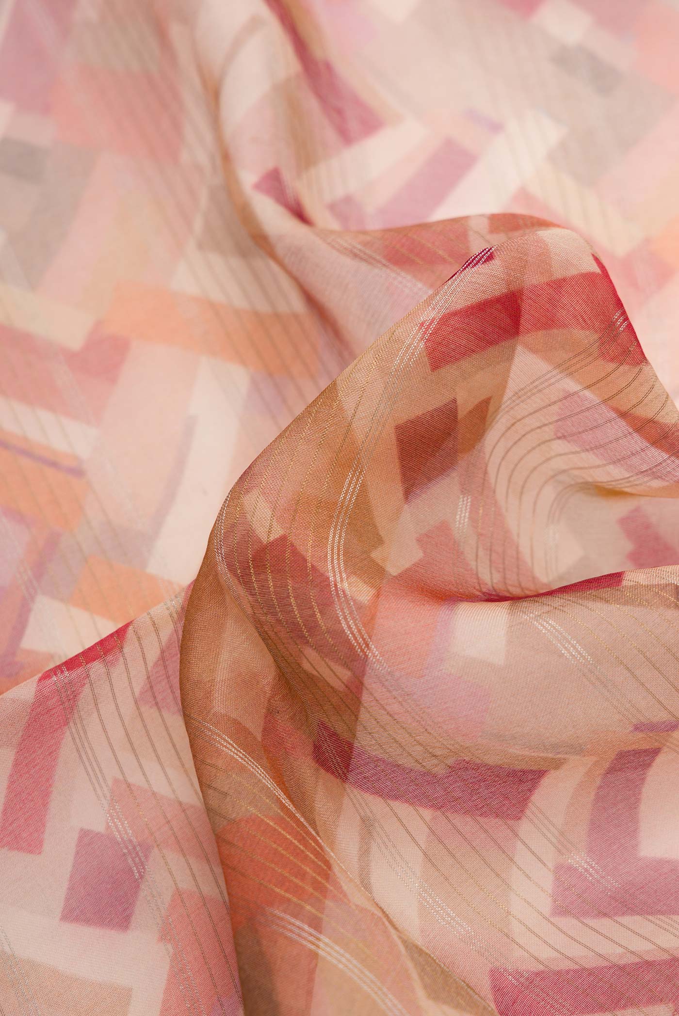 Close up of Brown Dual Tone Organza Silk Saree with Printed design on the body and Embroidery Border.  displaying folds