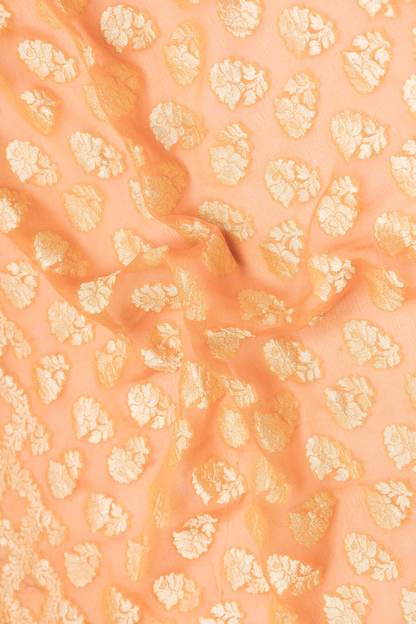 Close up of Peach Dual Tone Banarasi Georgette Saree with Zari Brocade on the body and Zari Border displaying folds