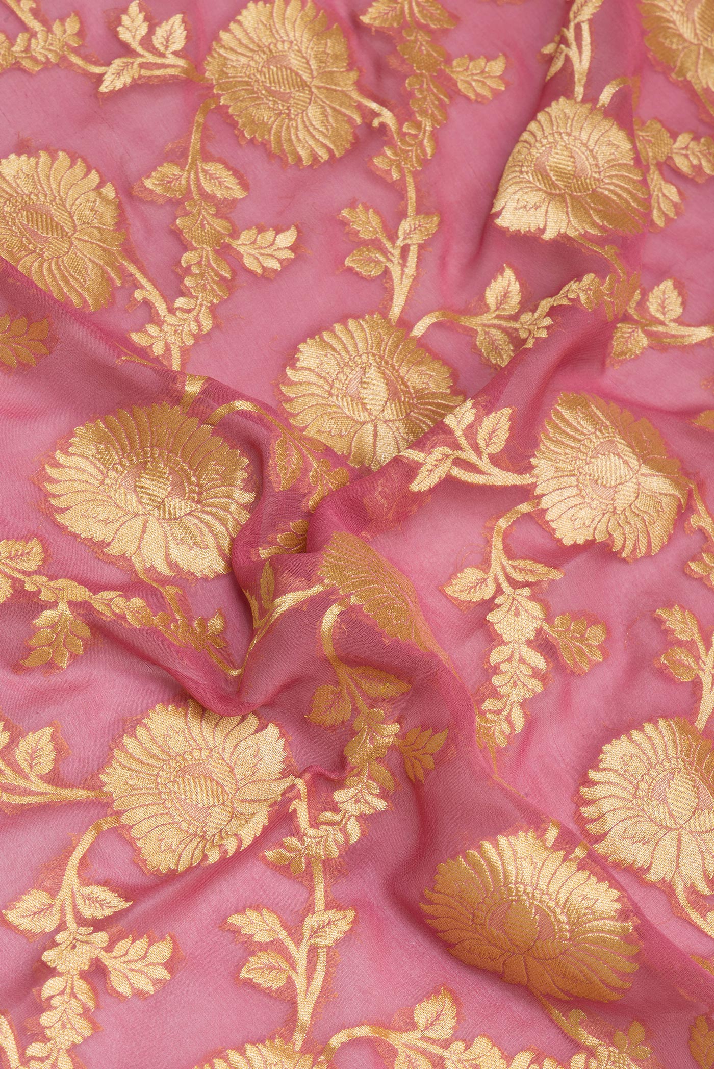 Close up of Pink Banarasi Georgette Saree with Zari Brocade on the body and Zari Border.  displaying folds