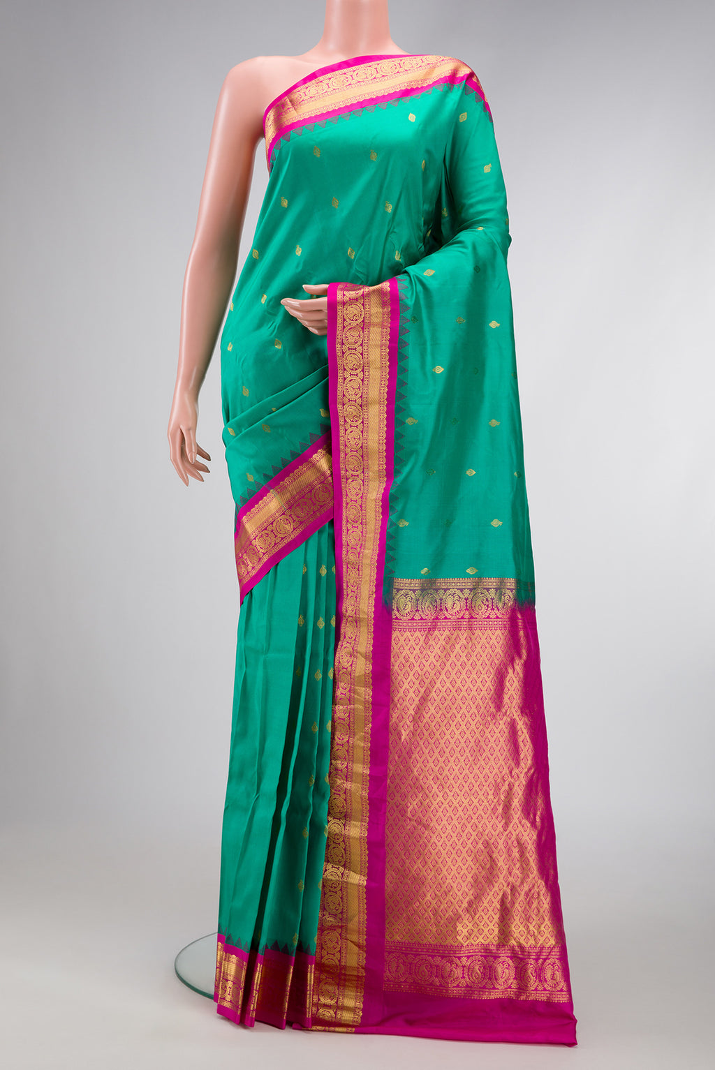Sea Green Gadwal Silk Saree with Zari Butta on the body and Zari Border.  displayed on a mannequin