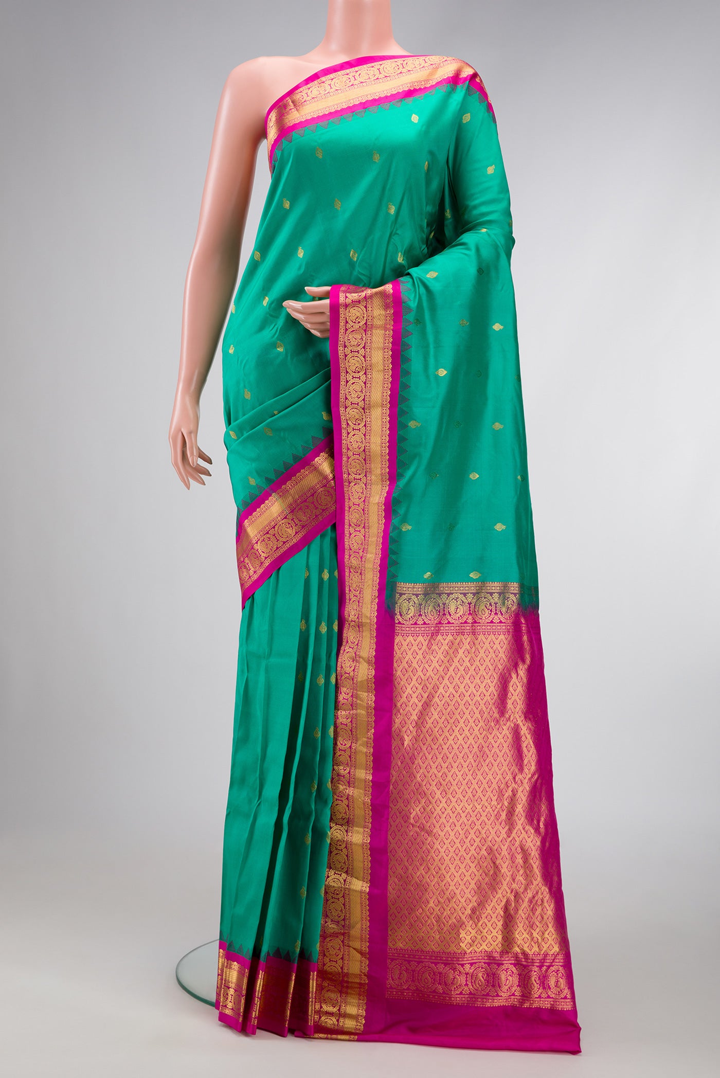 Sea Green Gadwal Silk Saree with Zari Butta on the body and Zari Border.  displayed on a mannequin