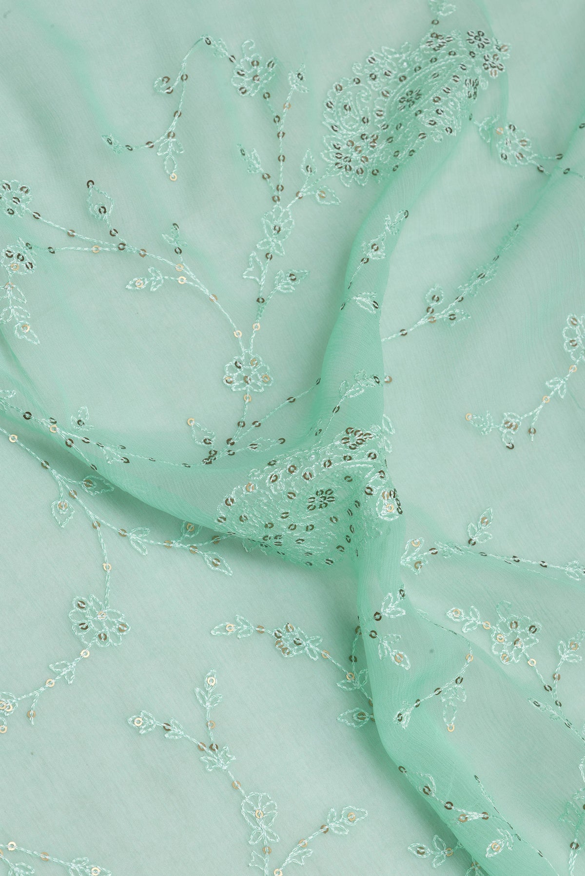 Close up of Sea Green Blended Chiffon Saree with Embroidery on the body and Embroidery Border.  displaying folds
