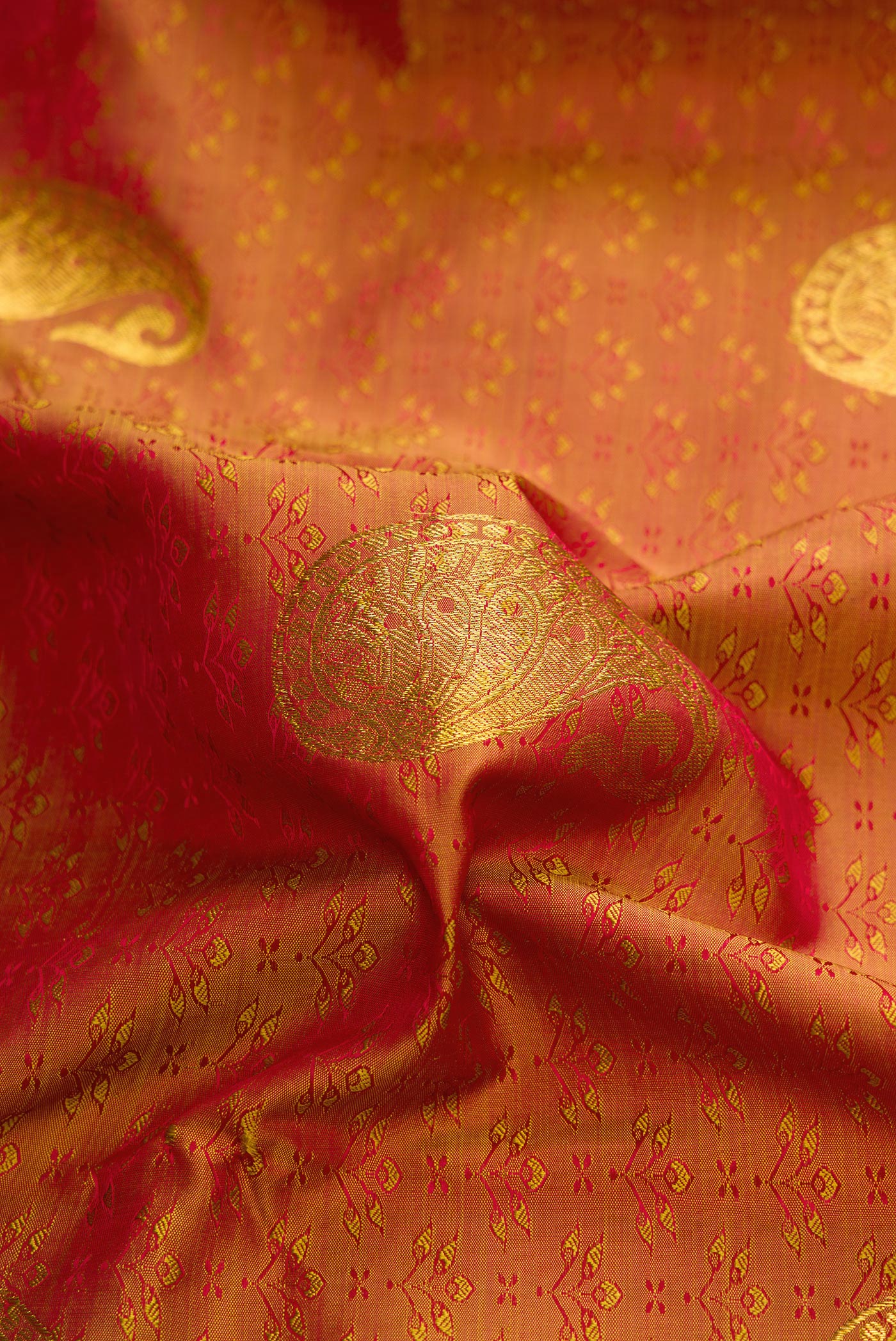 Close up of Bronze Dual Tone Kanchipuram Silk Saree with Jacquard With Zari Butta on the body and Zari Border.  displaying folds