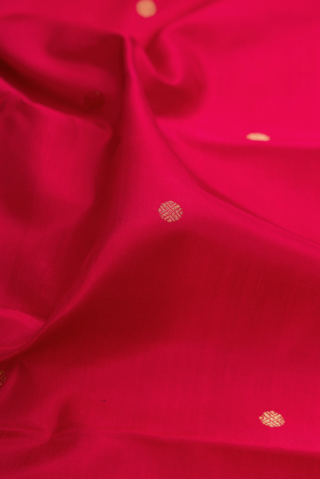 Close up of Pure Silk Pure Zari Maroon Kanchipuram Saree with Zari Butta on the body and Fancy Border.  displaying folds