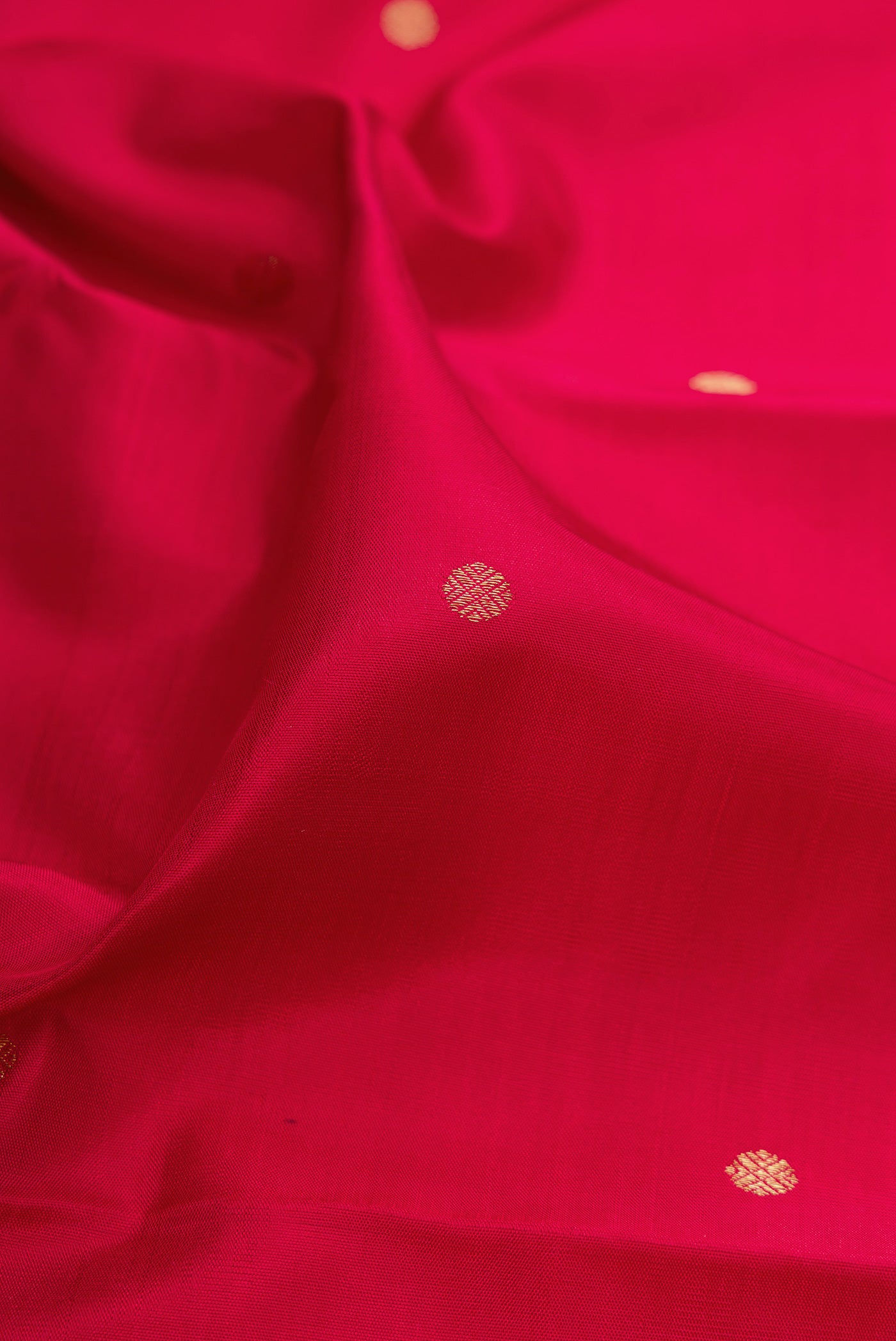 Close up of Pure Silk Pure Zari Maroon Kanchipuram Saree with Zari Butta on the body and Fancy Border.  displaying folds