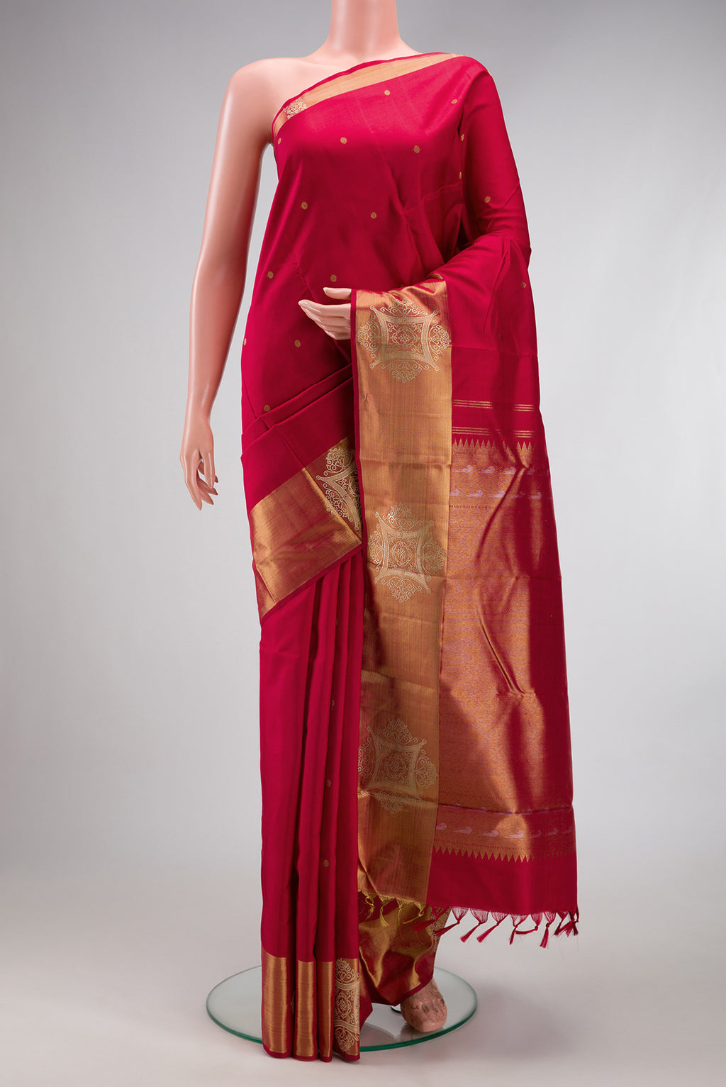 Pure Silk Pure Zari Maroon Kanchipuram Saree with Zari Butta on the body and Fancy Border.  displayed on a mannequin