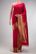 Pure Silk Pure Zari Maroon Kanchipuram Saree with Zari Butta on the body and Fancy Border.  displayed on a mannequin