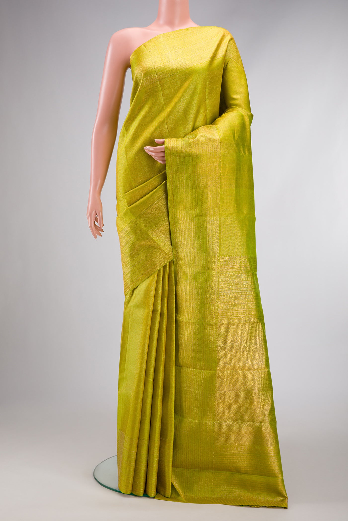 Parrot Green Dual Tone Kanjivaram Silk Saree with Zari Brocade on the body and Zari Border.  displayed on a mannequin