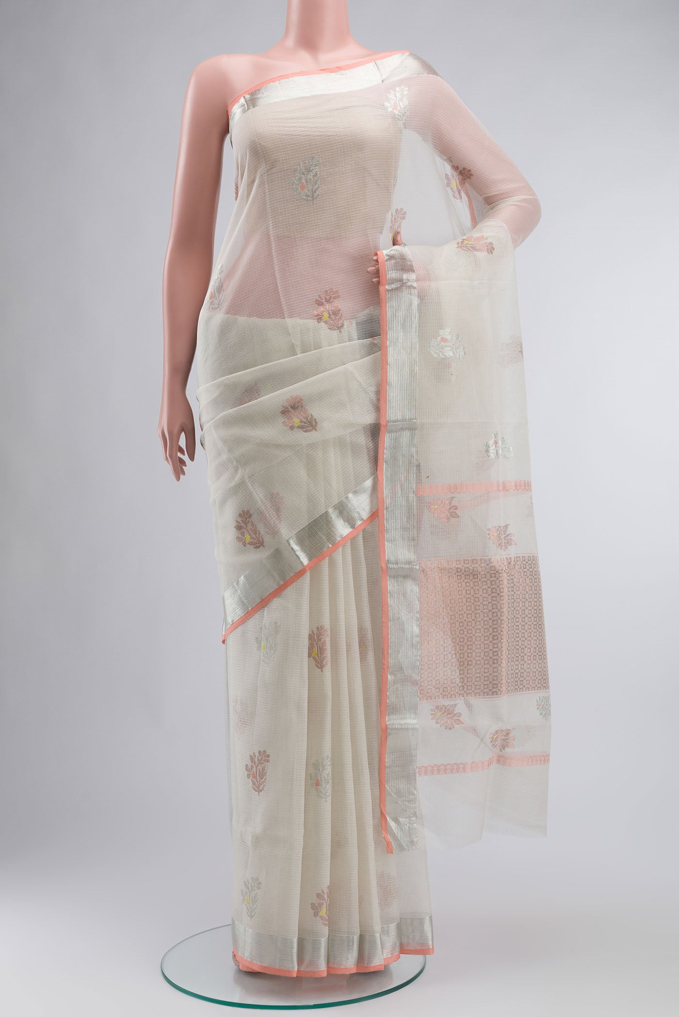 Peach Kota Silk Saree with Zari And Thread Butta on the body and Zari Border displayed on a mannequin