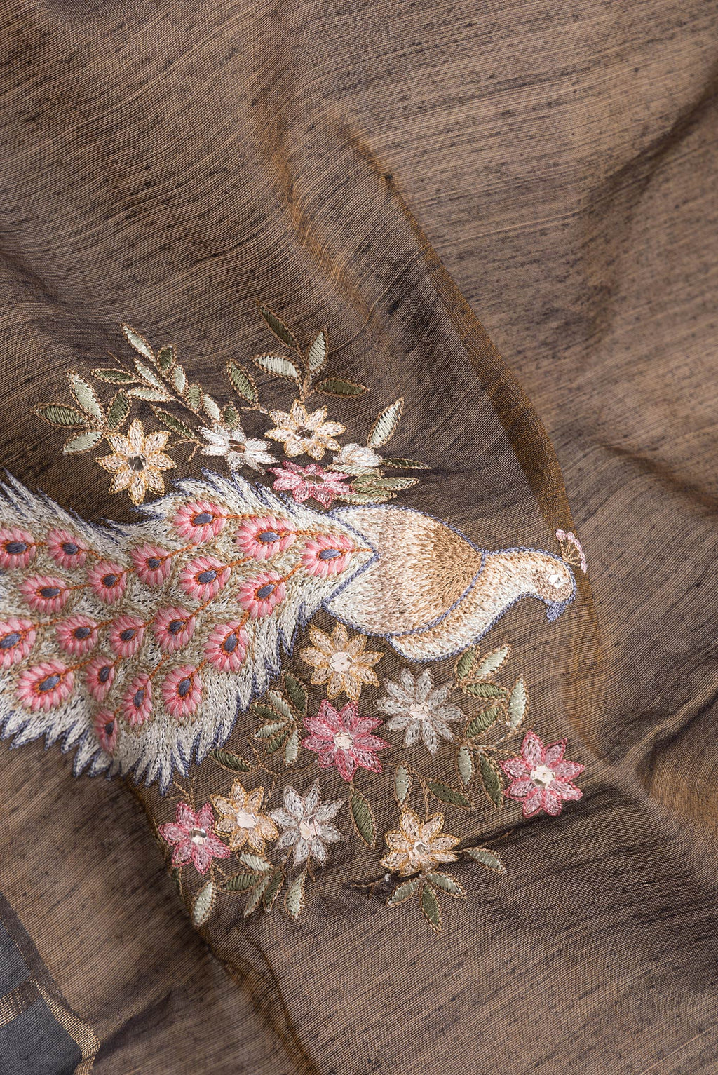 Close up of Brown Dual Tone Tussar Silk Saree with Embroidery on the body and Checks Border.  displaying folds
