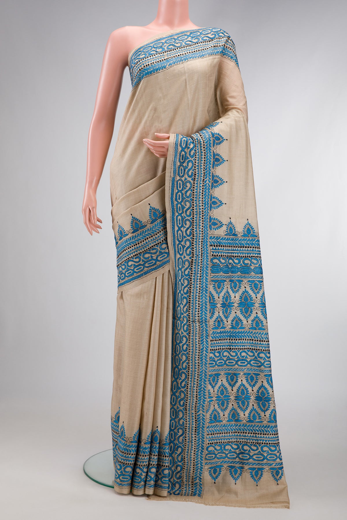 Beige Dual Tone Tussar Silk Saree with Plain Body and Printed Border.  displayed on a mannequin