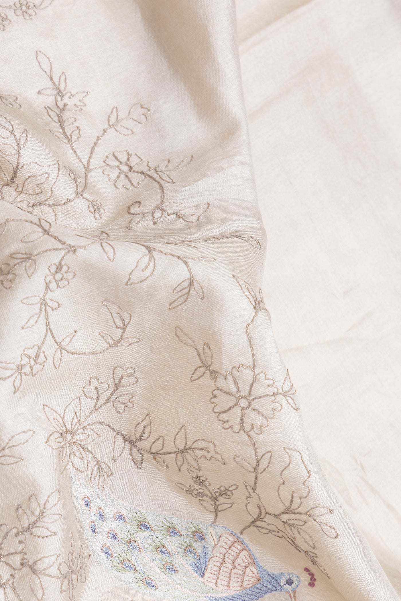 Close up of Grey Dual Tone Tussar Silk Saree with Embroidery on the body and Embroidery Border.  displaying folds