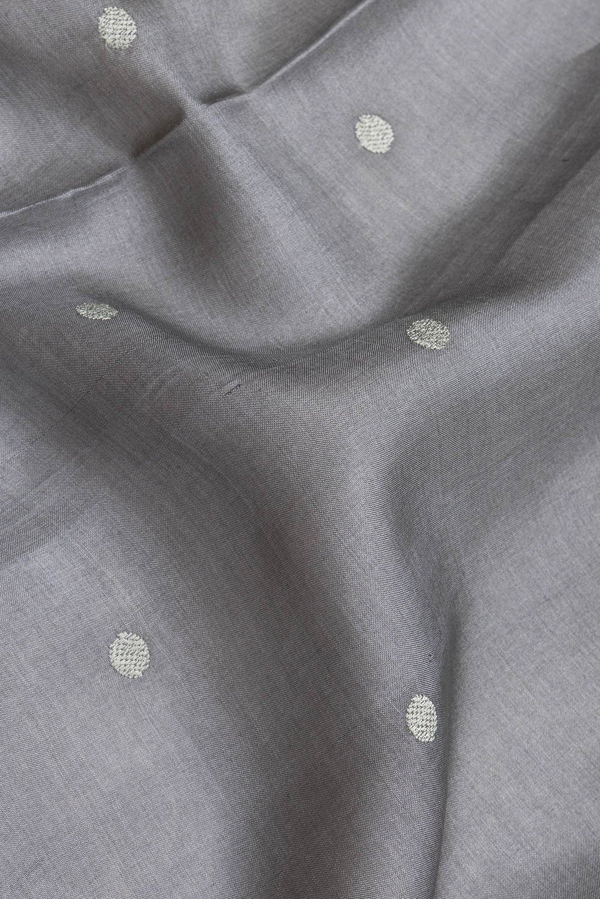 Close up of Grey Dual Tone Tussar Silk Saree with Embroidery on the body and Embroidery Border.  displaying folds