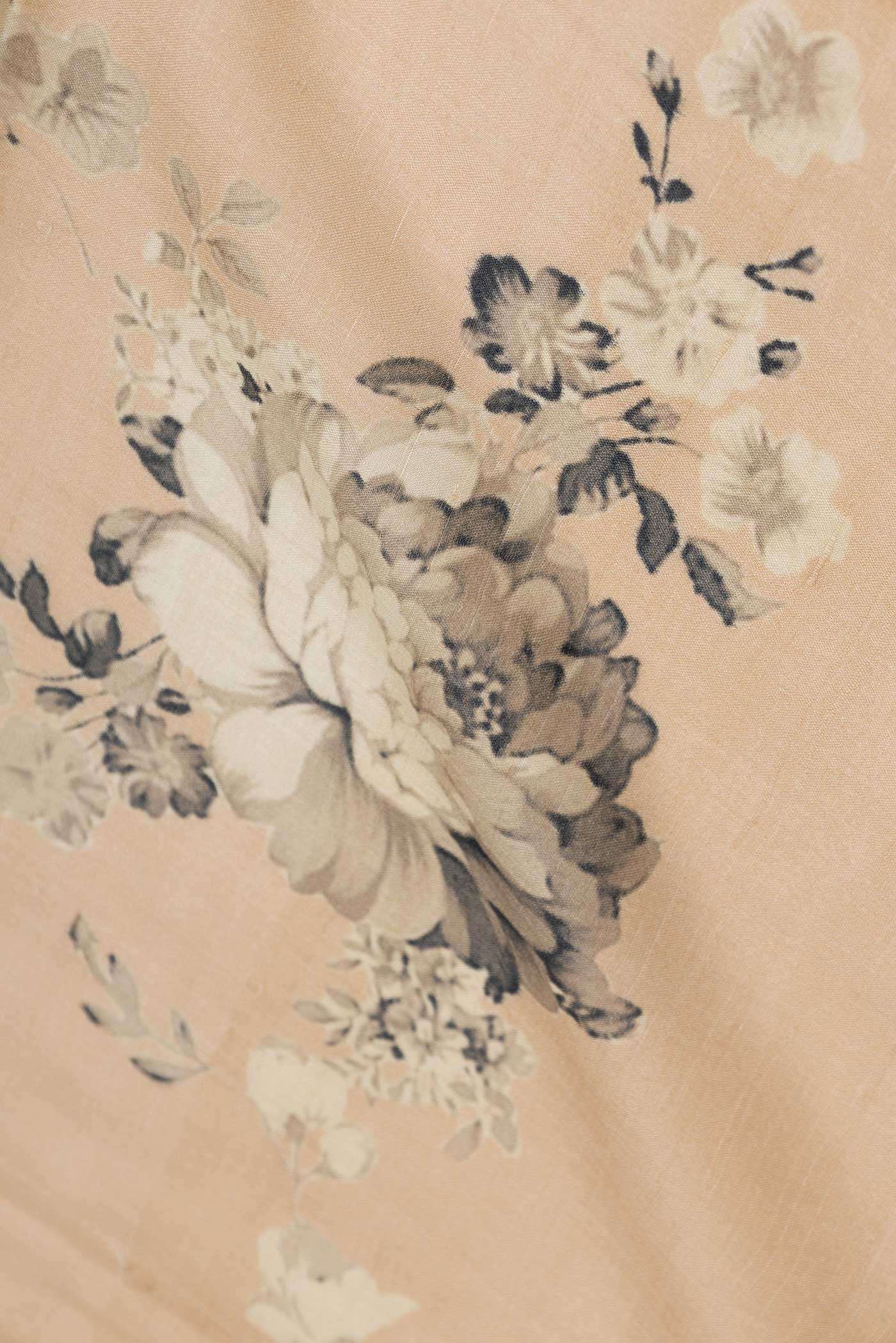 Close up of Beige Dual Tone Tussar Saree with Printed design on the body and Zari Border displaying folds