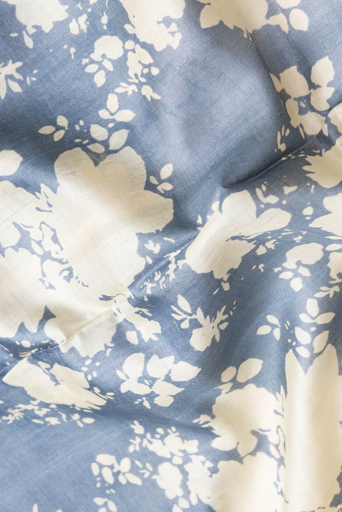 Close up of Grey Dual Tone Tussar Silk Saree with Printed design on the body and Embroidery Border.  displaying folds