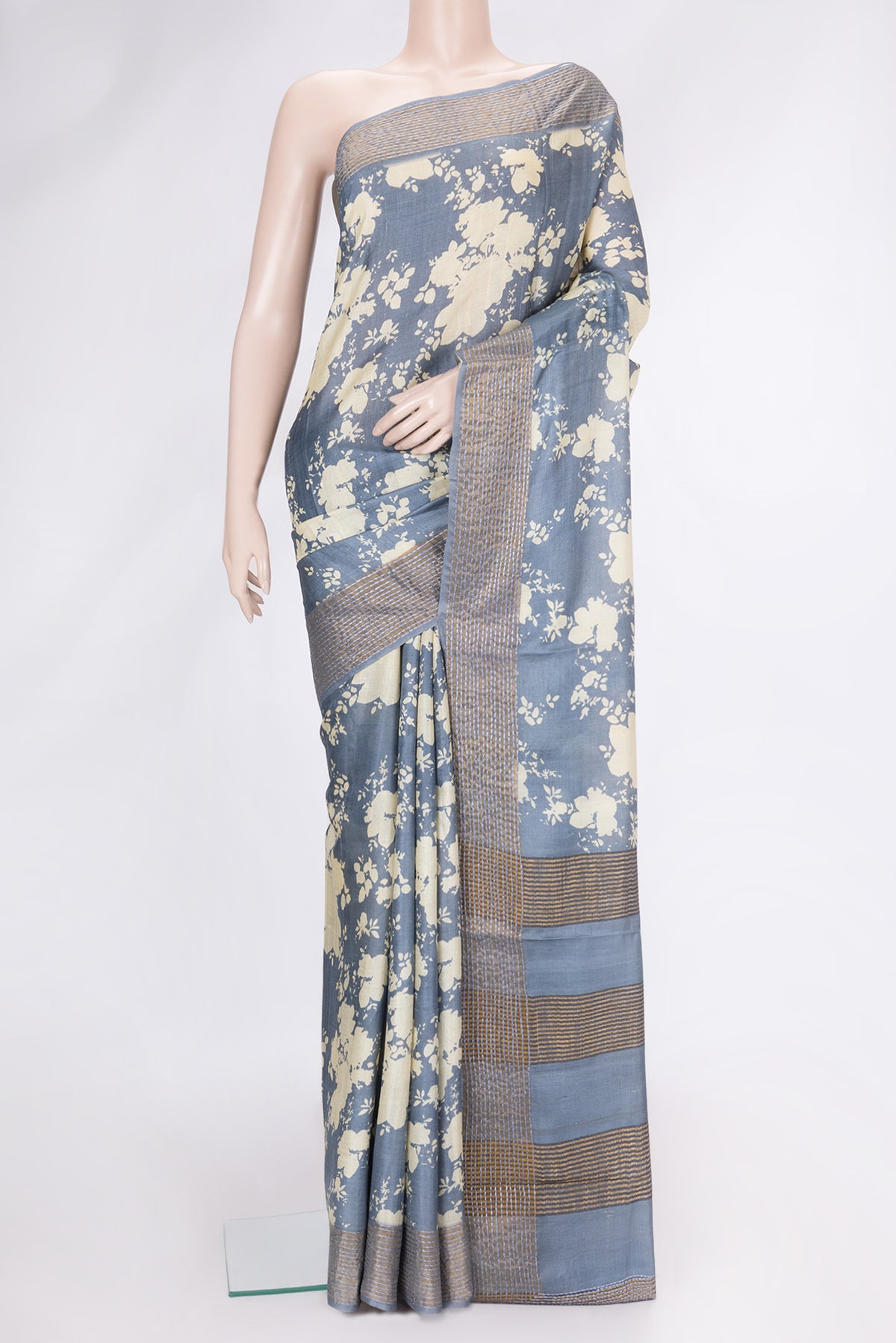 Grey Dual Tone Tussar Silk Saree with Printed design on the body and Embroidery Border.  displayed on a mannequin