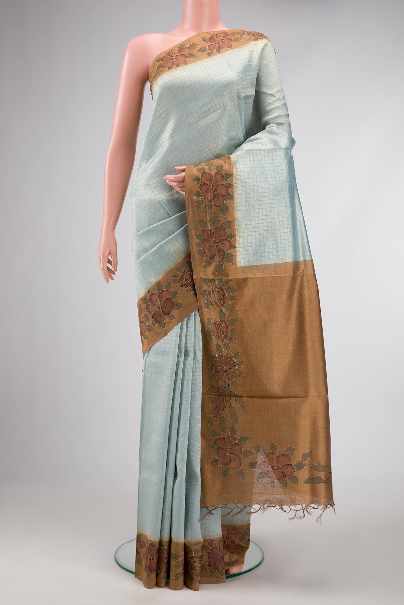 Maya Blue Dual Tone Tussar Silk Saree with Zari Brocade on the body and Embroidery Border.  displayed on a mannequin