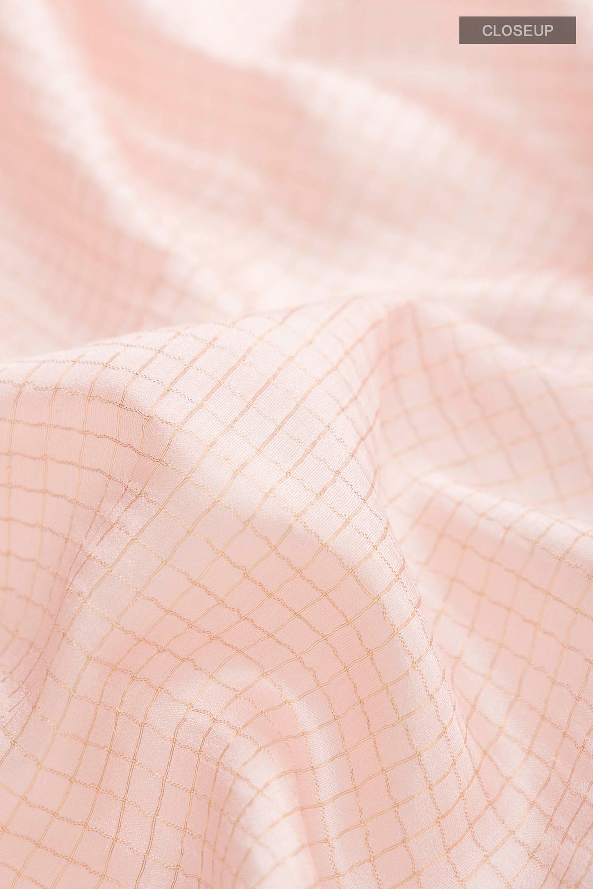 Close up of Rose pink Bhagalpuri Tussar Silk Saree with Checked design on the body and Embroidery Border displaying folds