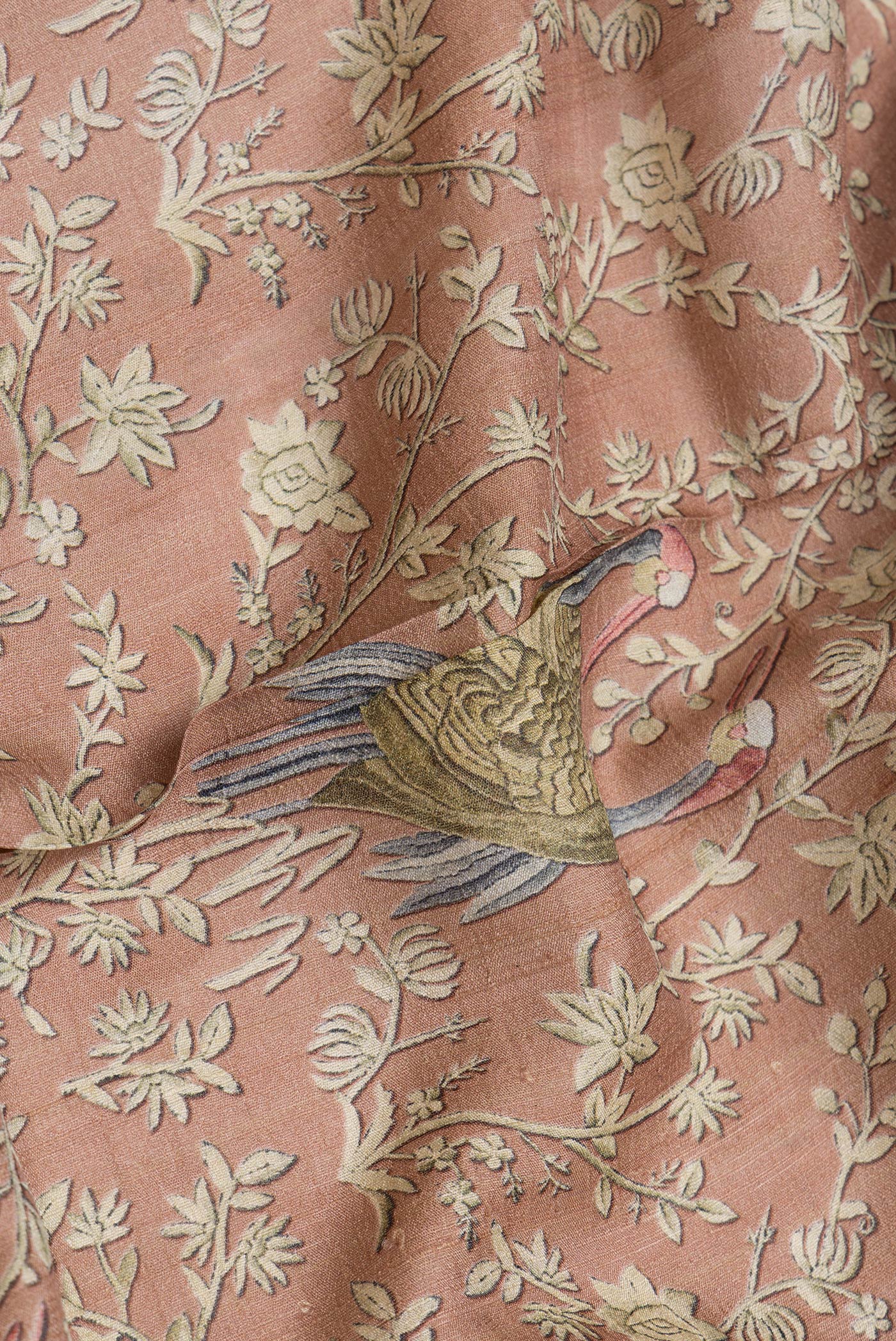 Close up of Brown Dual Tone Tussar Silk Saree with Printed design on the body and Embroidery Border.  displaying folds