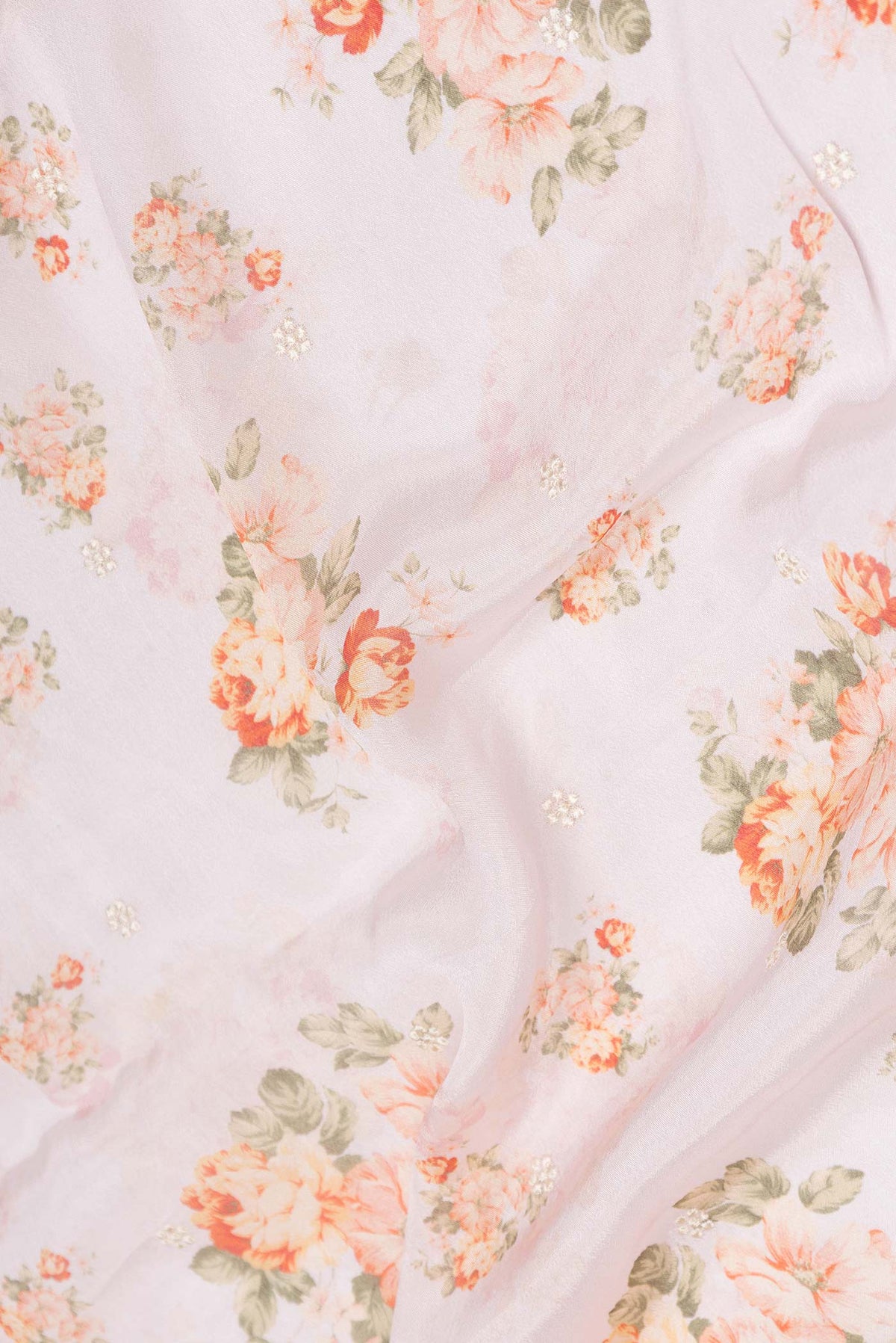 Close up of Pink Dual Tone Mysore Crepe Saree with Printed design on the body and Embroidery Border displaying folds