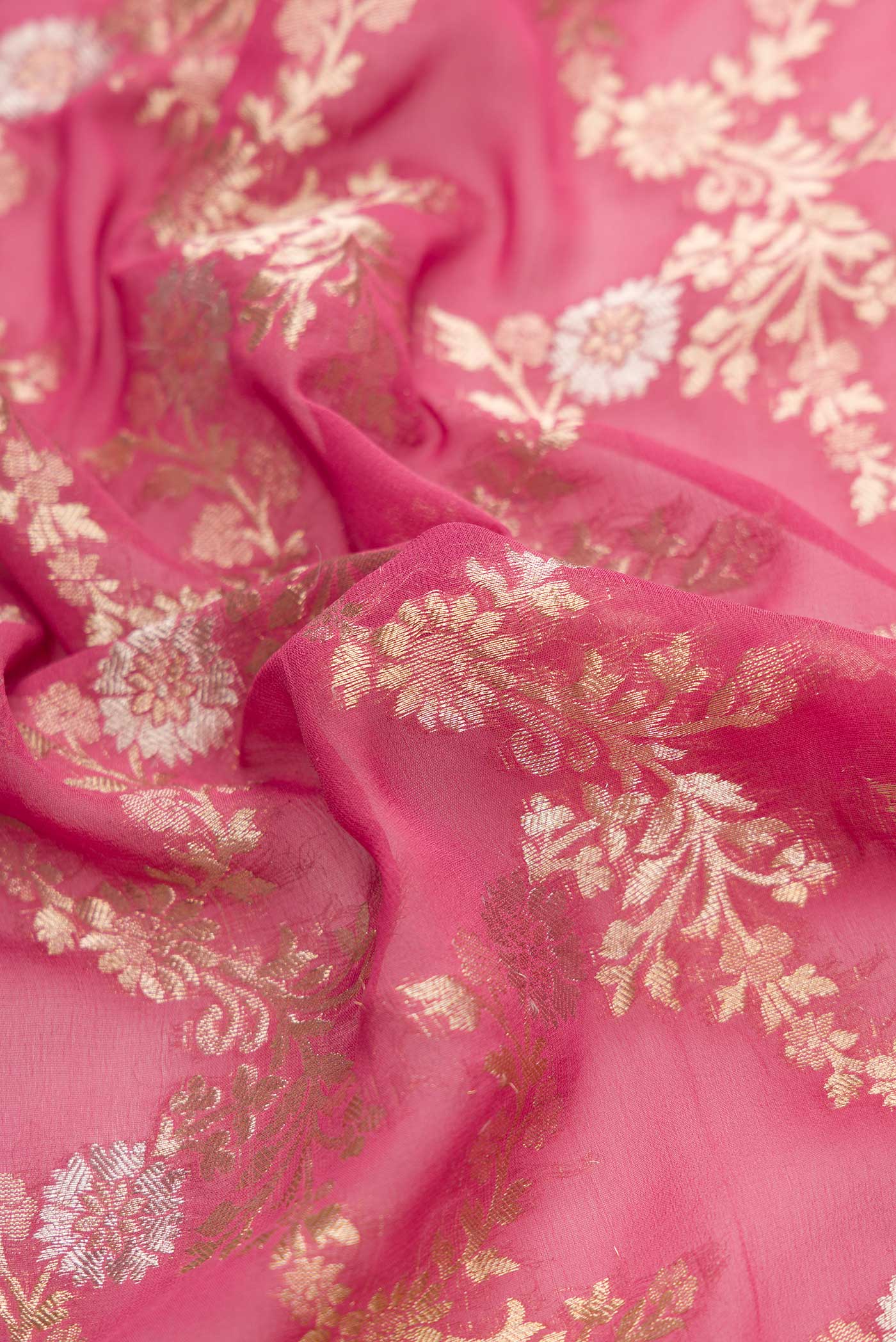 Close up of Pink Dual Tone Banarasi Georgette Saree with Zari Brocade on the body and Zari Border.  displaying folds
