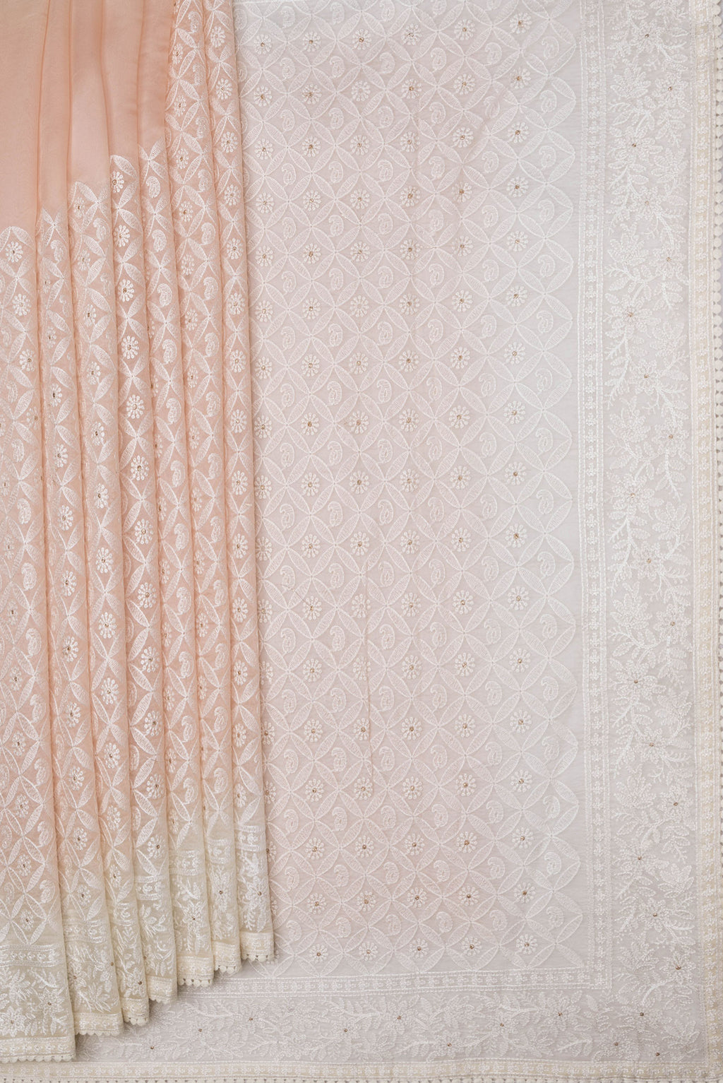 Pleats and pallu of Golden Peach Dual Tone Organza Silk Saree with Embroidery on the body and Embroidery Border. 