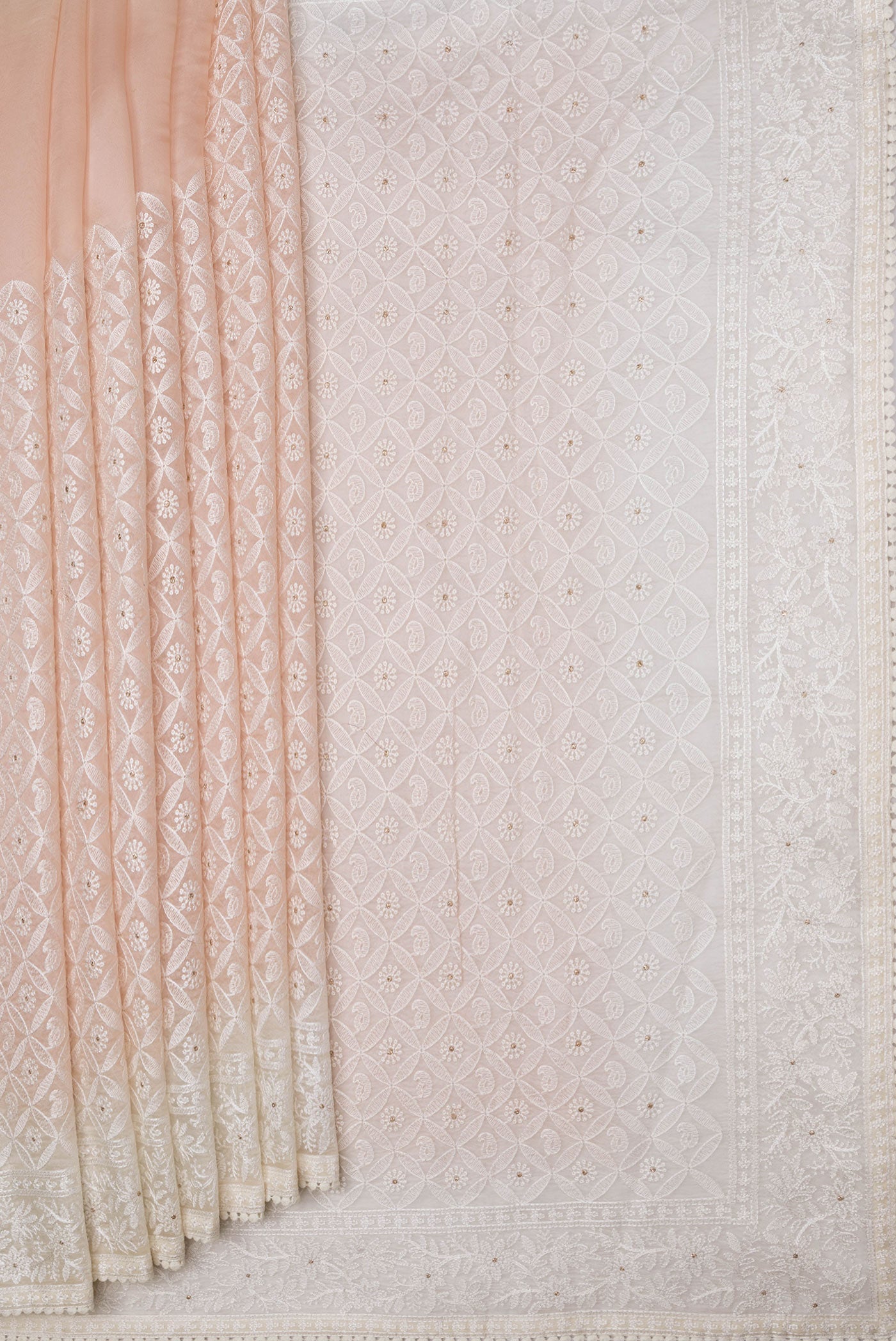 Pleats and pallu of Golden Peach Dual Tone Organza Silk Saree with Embroidery on the body and Embroidery Border. 