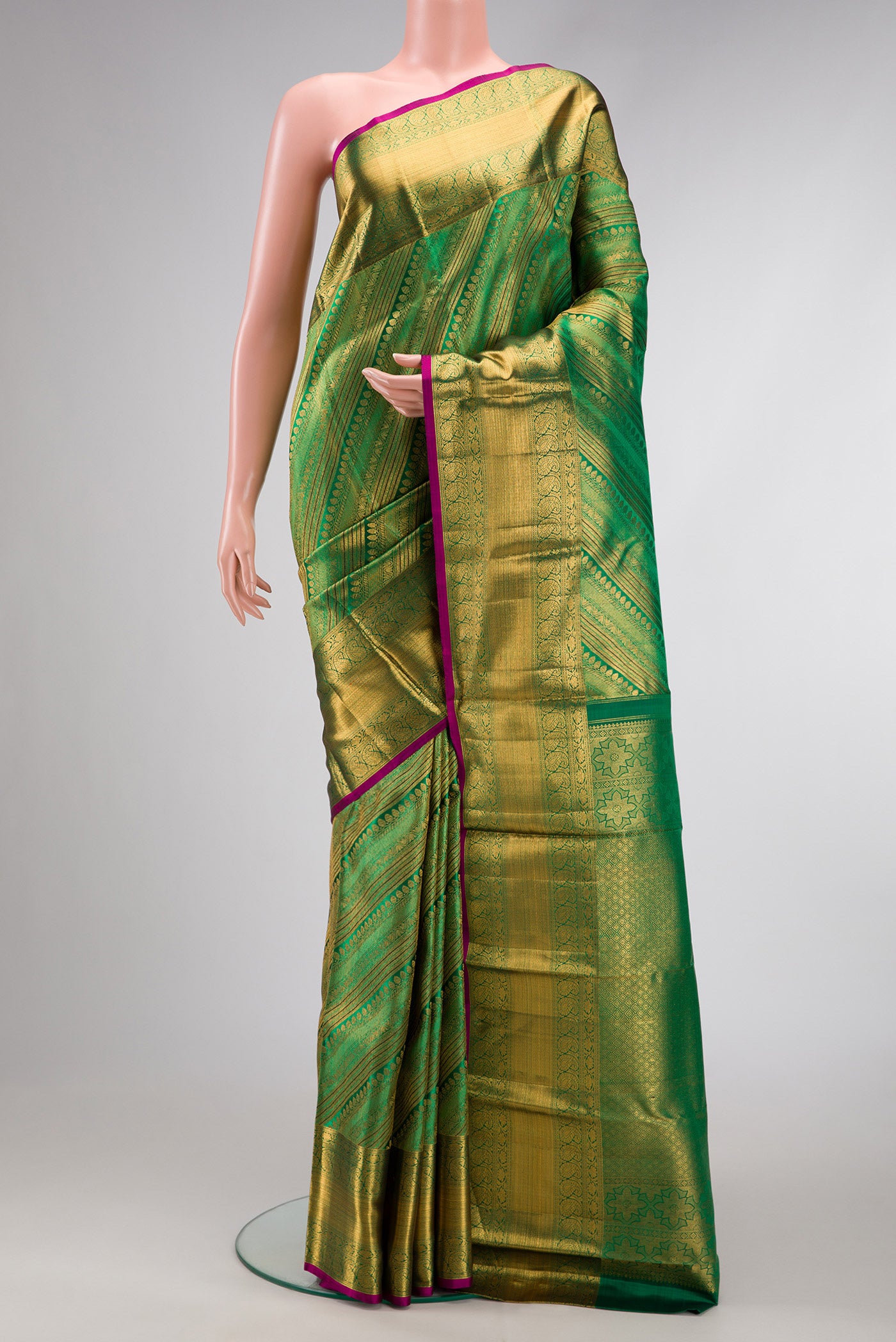Green Dual Tone Kanchipuram Silk Saree with Zari Brocade on the body and Zari Border.  displayed on a mannequin