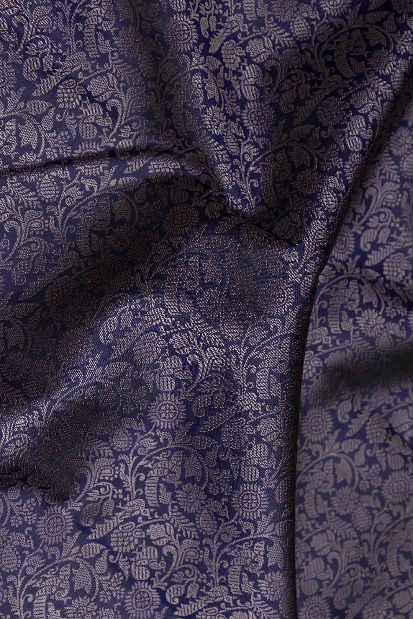 Close up of Navy Blue Dual Tone Kanchipuram Saree with Jacquard design on the body and Zari Border displaying folds