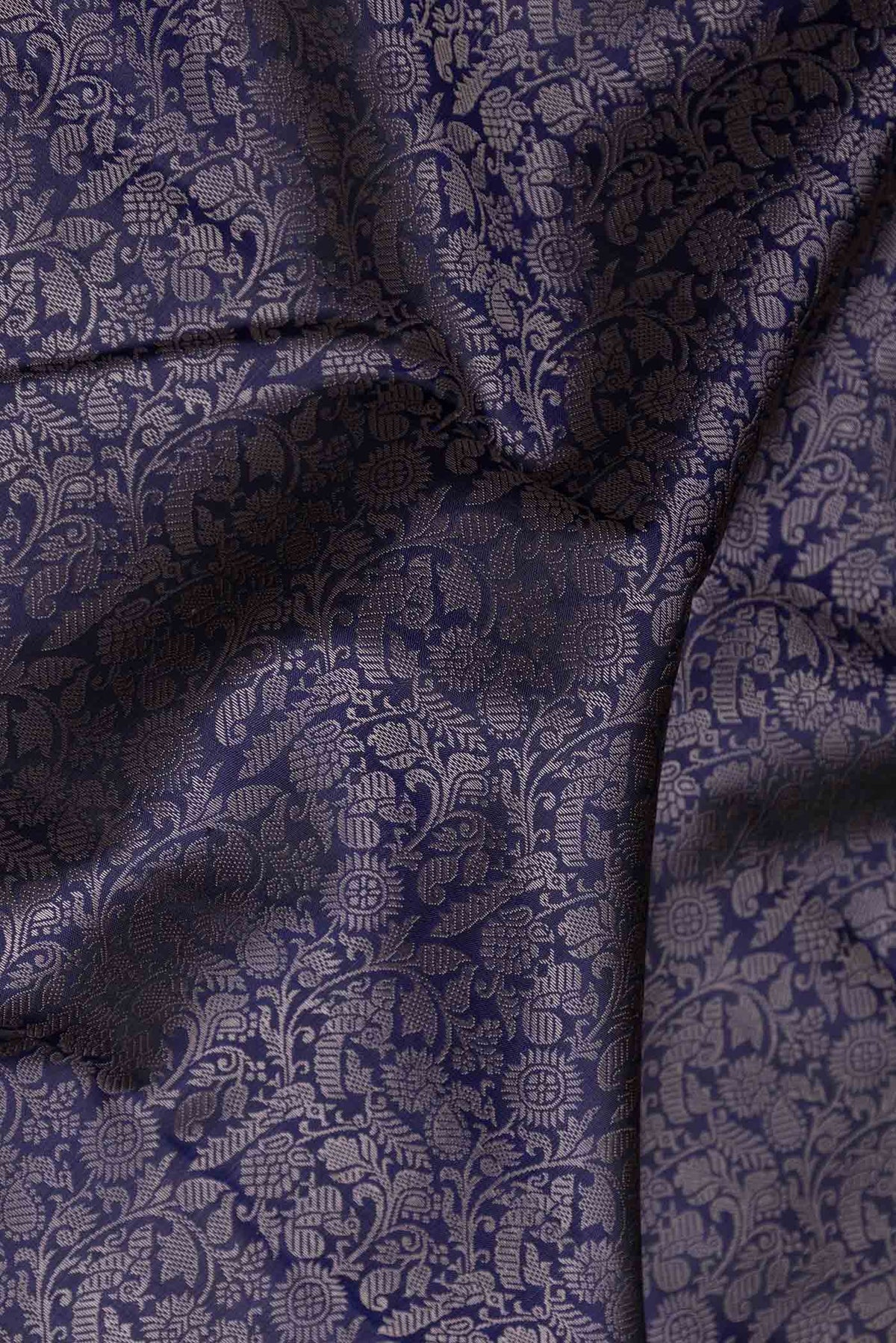 Close up of Navy Blue Dual Tone Kanchipuram Saree with Jacquard design on the body and Zari Border displaying folds