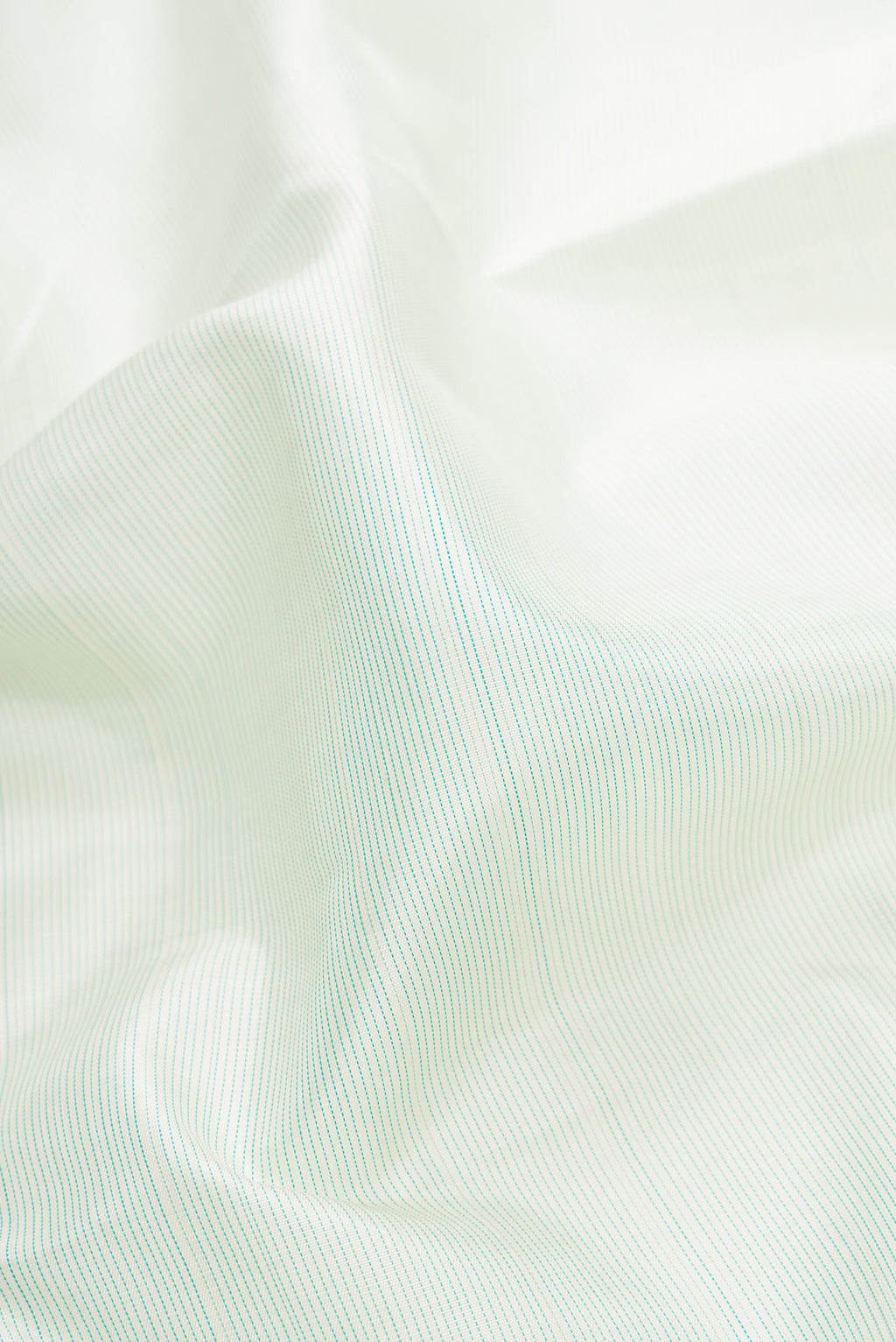 Close up of Pista Green Dual Tone Kanjivaram Silk Saree with Stripes on the body and Fancy Border.  displaying folds