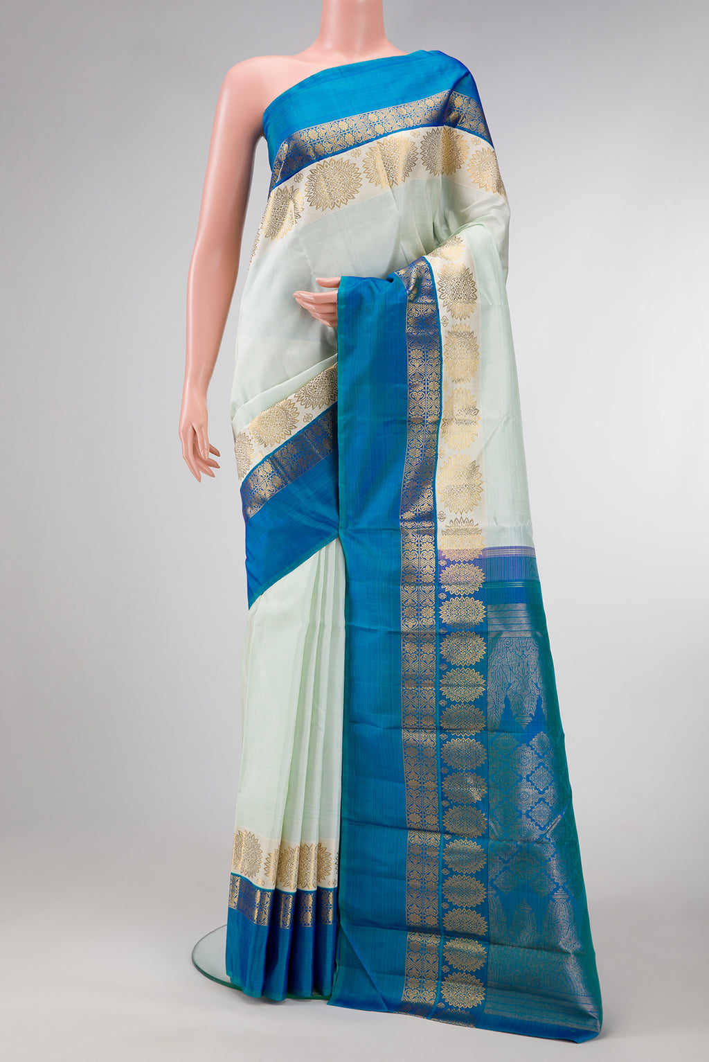 Pista Green Dual Tone Kanjivaram Silk Saree with Stripes on the body and Fancy Border.  displayed on a mannequin