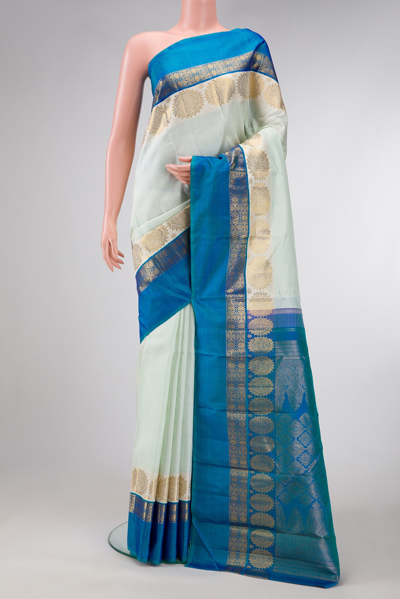 Pista Green Dual Tone Kanjivaram Silk Saree with Stripes on the body and Fancy Border.  displayed on a mannequin