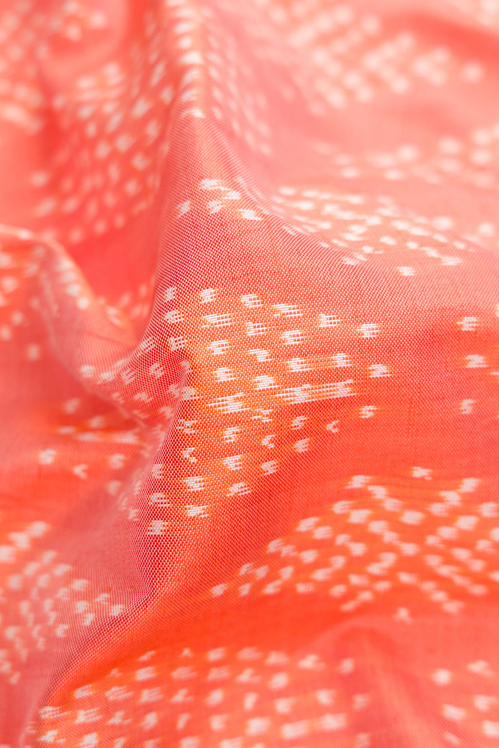 Close up of Golden Peach Dual Tone Double Ikat Saree with Ikat Print on the body and Ikat Border.  displaying folds