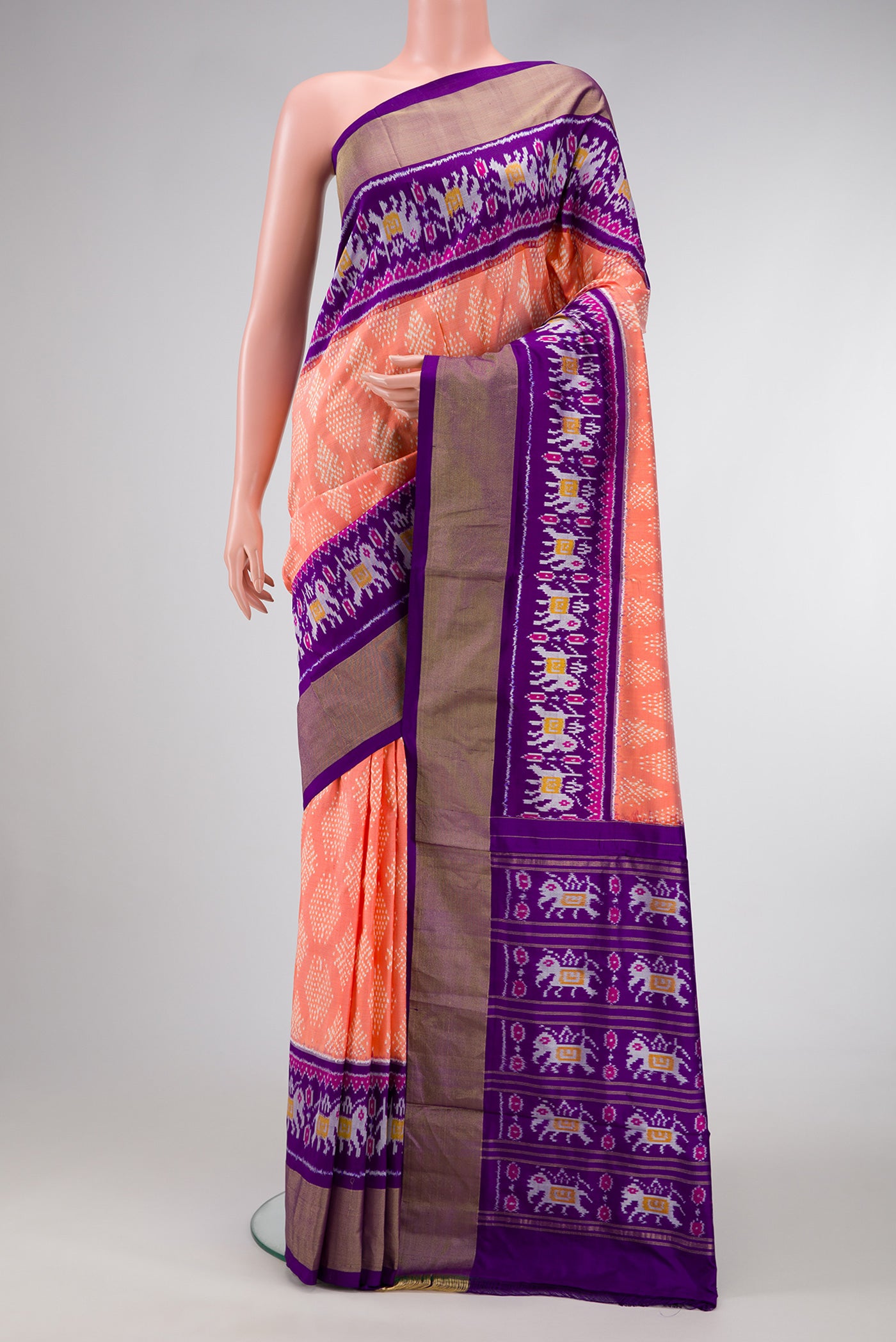 Golden Peach Dual Tone Double Ikat Saree with Ikat Print on the body and Ikat Border.  displayed on a mannequin