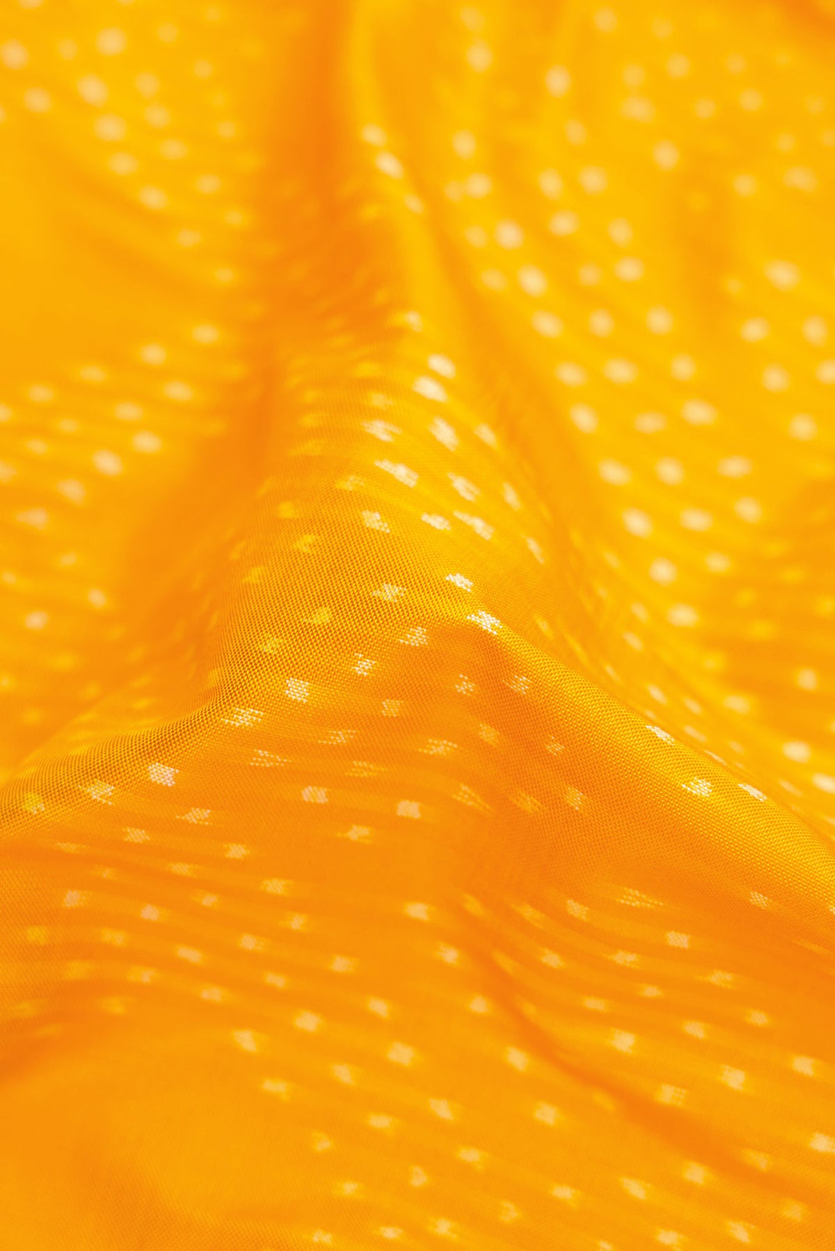 Close up of Yellow Pochampally Silk Saree with Pure Ikat on the body and Zari Border displaying folds