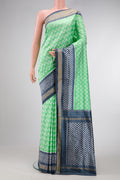 Pista Green Dual Tone Double Ikat Saree with Ikat Print on the body and Ikat Border.  displayed on a mannequin