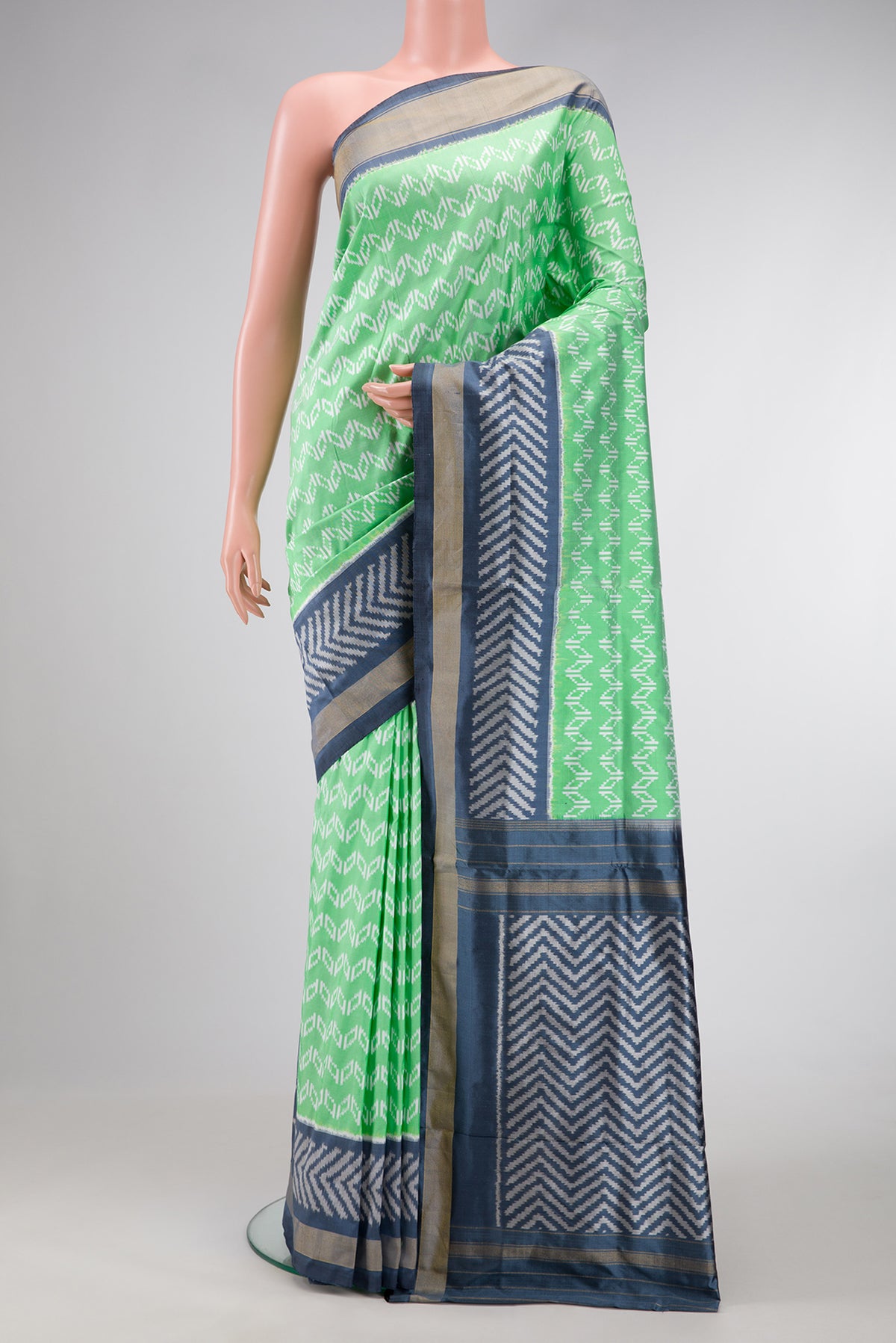 Pista Green Dual Tone Double Ikat Saree with Ikat Print on the body and Ikat Border.  displayed on a mannequin