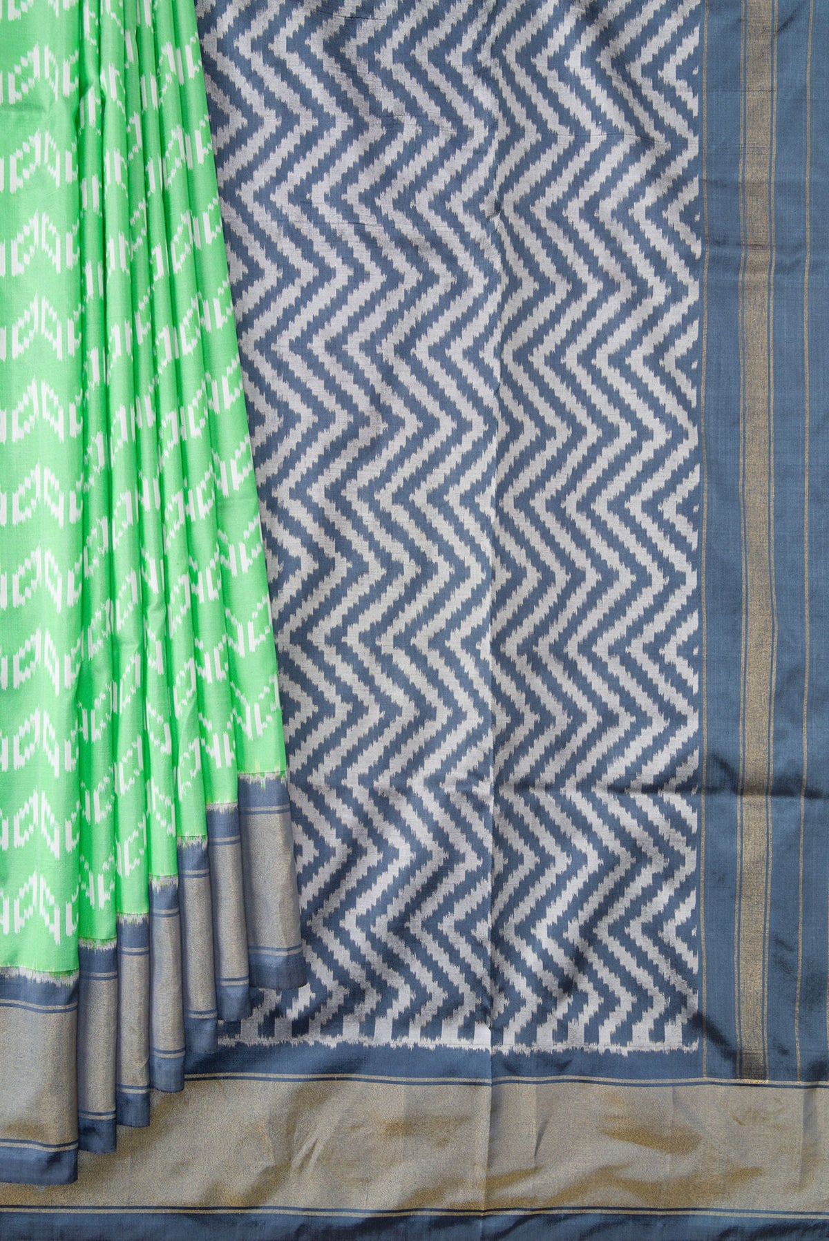 Pleats and pallu of Pista Green Dual Tone Double Ikat Saree with Ikat Print on the body and Ikat Border. 