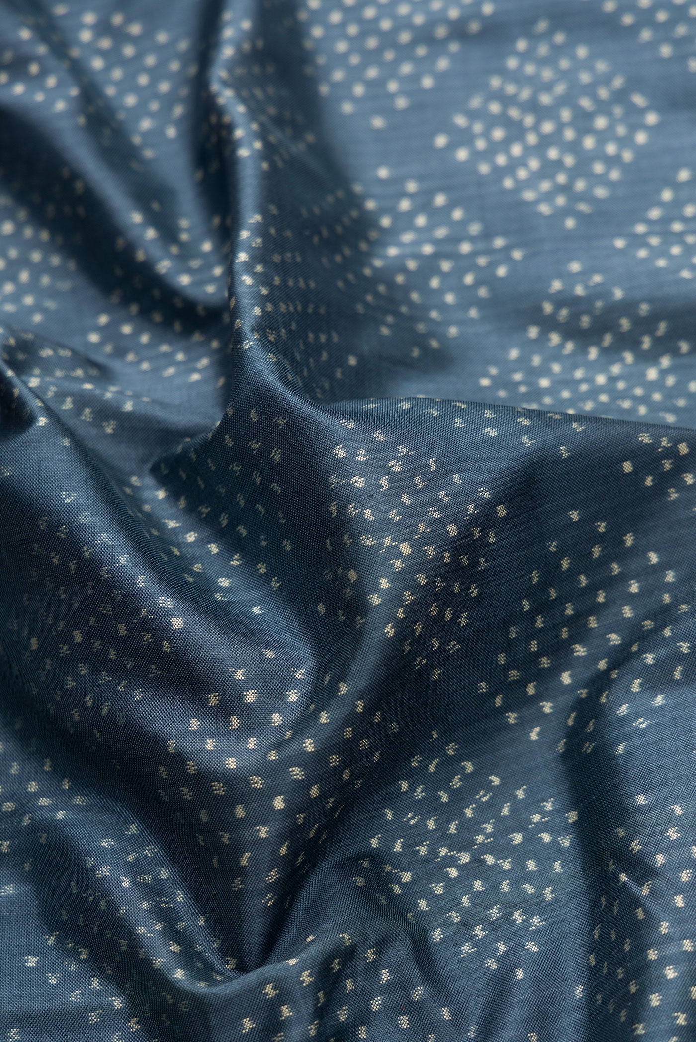 Close up of Grey Dual Tone Double Ikat Saree with Ikat Print on the body and Ikat Border.  displaying folds