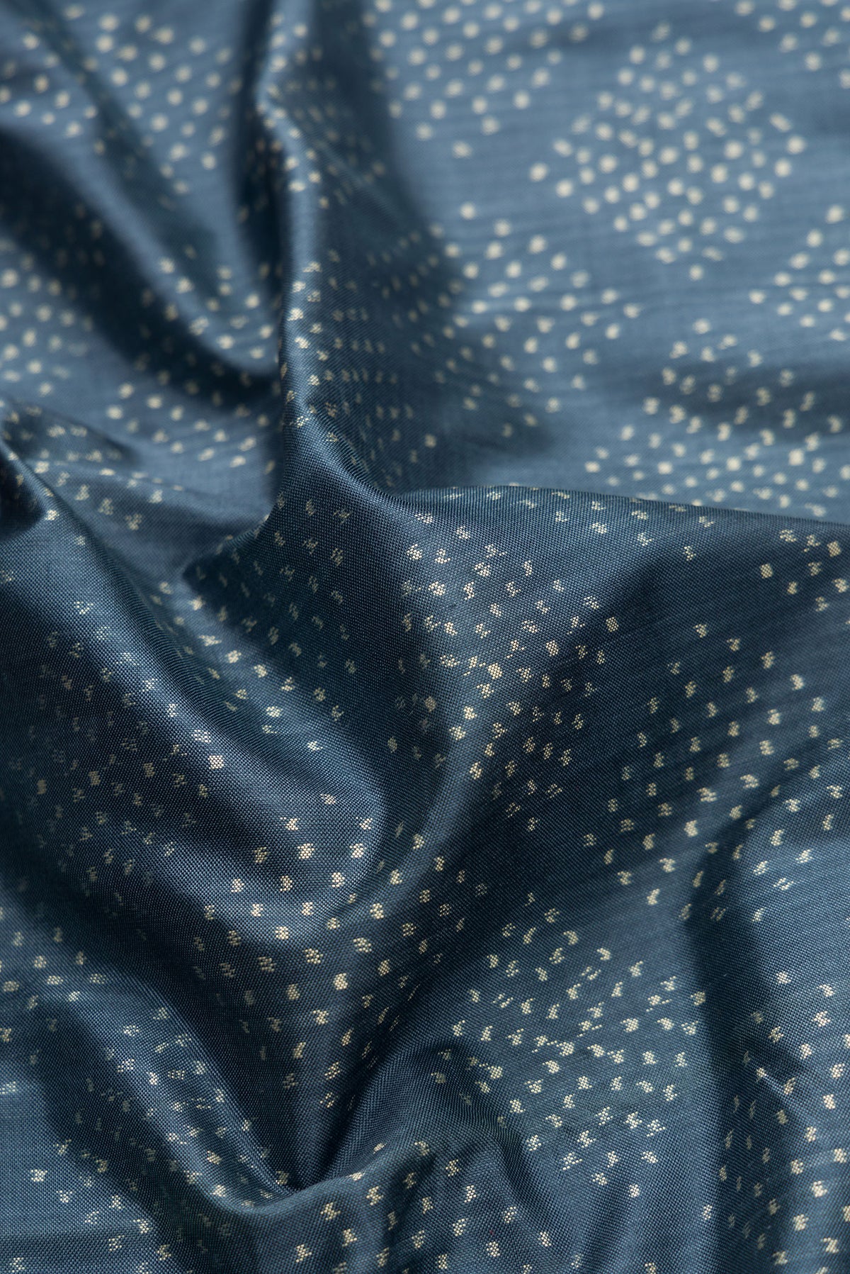 Close up of Grey Dual Tone Double Ikat Saree with Ikat Print on the body and Ikat Border.  displaying folds