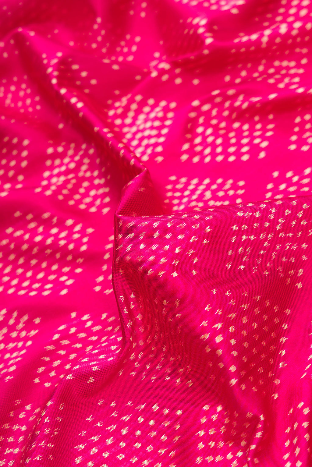 Close up of Pink Dual Tone Double Ikat Saree with Ikat Print on the body and Ikat Border.  displaying folds